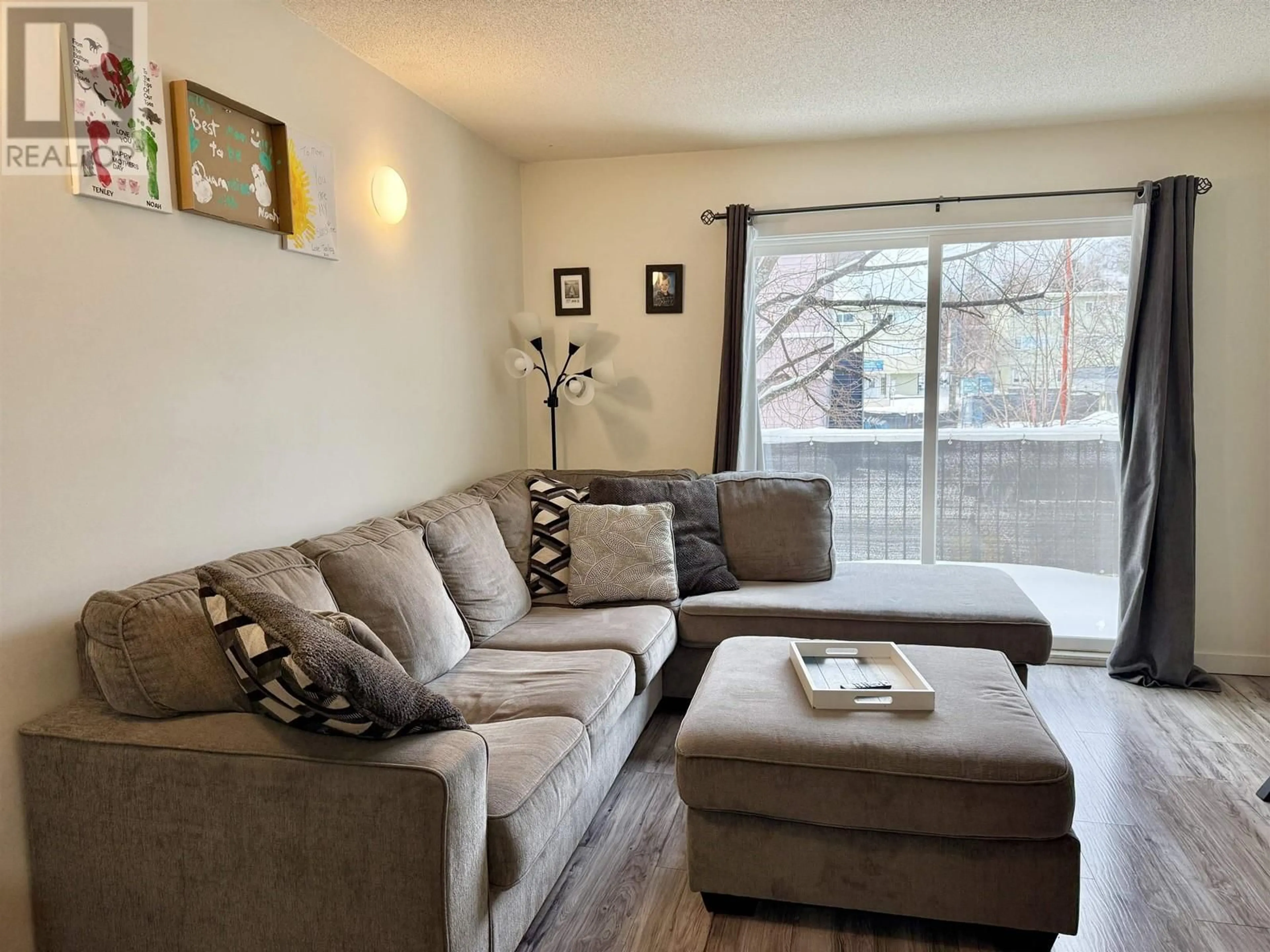 Living room with furniture, wood/laminate floor for 210 1601 INGLEDEW STREET, Prince George British Columbia V2L1K6