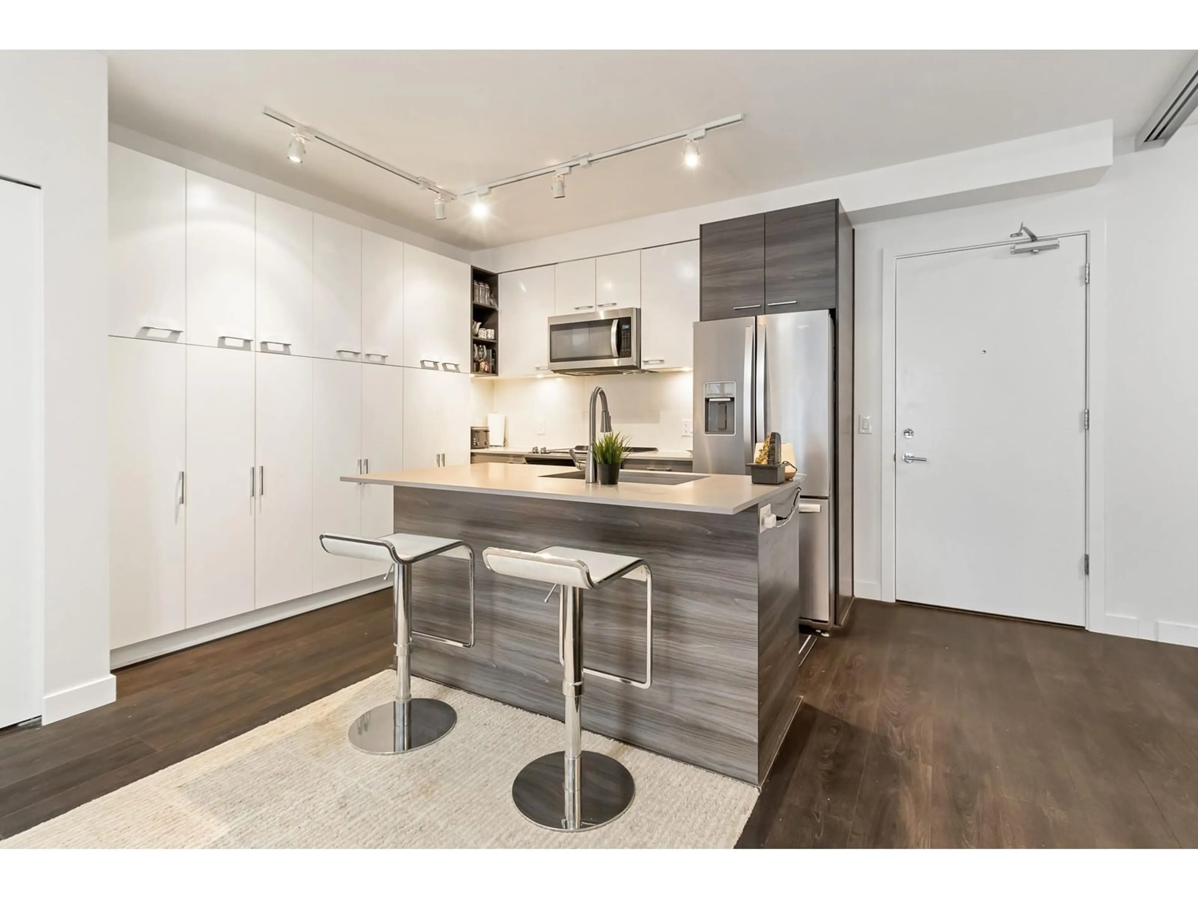 Open concept kitchen, wood/laminate floor for 221 13963 105 BOULEVARD, Surrey British Columbia V3T0M9