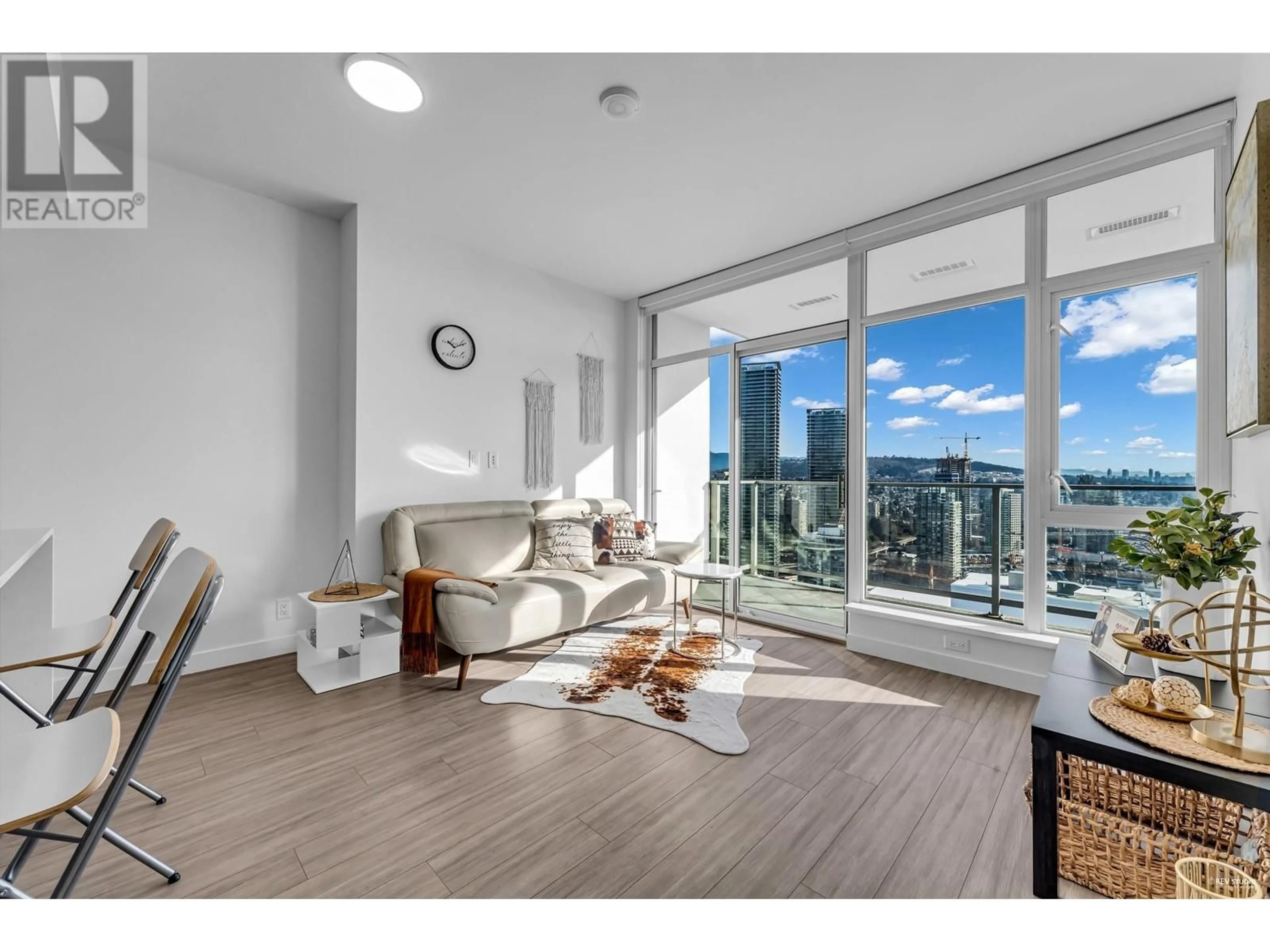 Living room with furniture, wood/laminate floor for 3404 2311 BETA AVENUE, Burnaby British Columbia V5C0M1