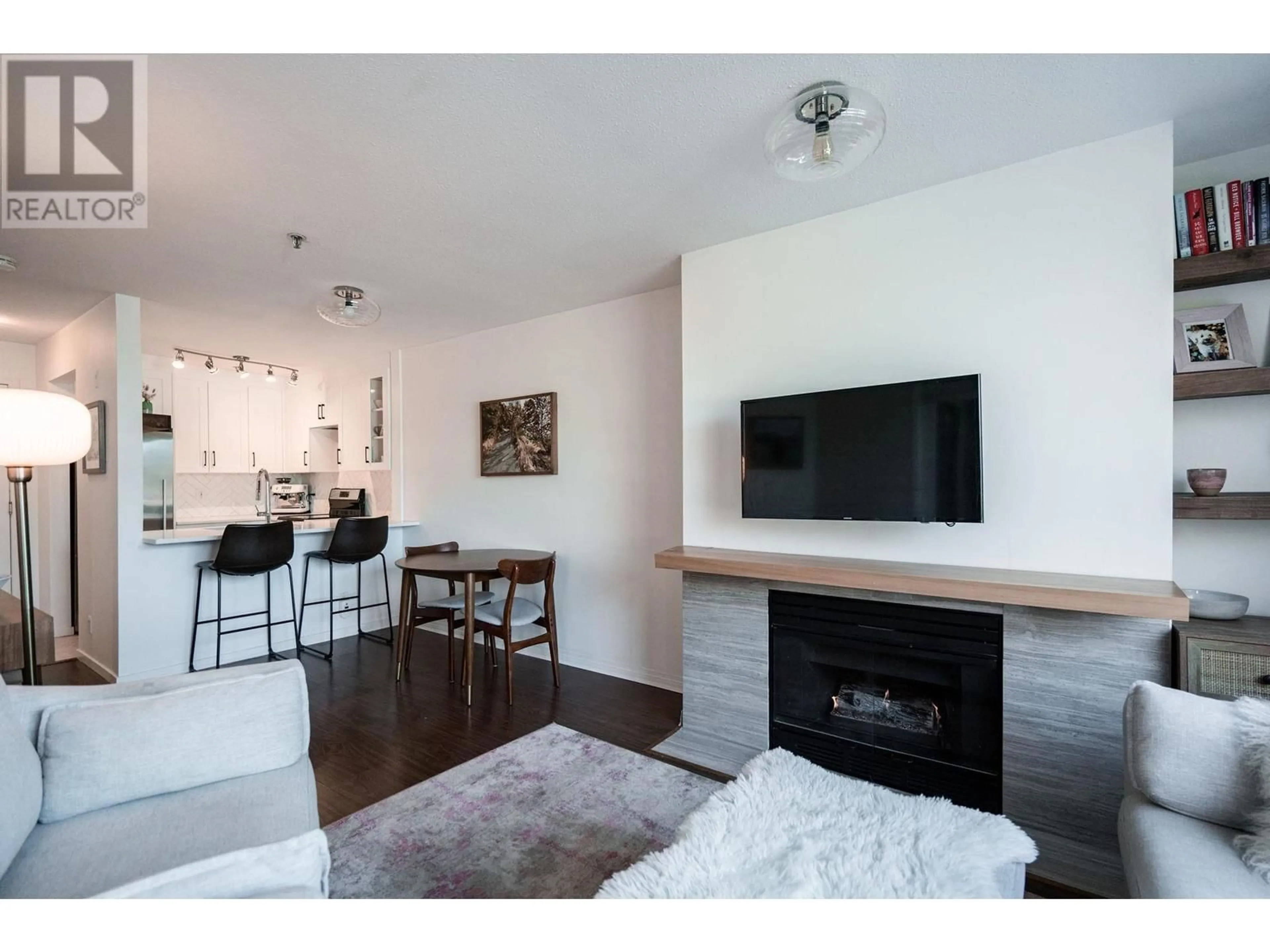 Living room with furniture, wood/laminate floor for 207 2160 CORNWALL AVENUE, Vancouver British Columbia V6K1B4