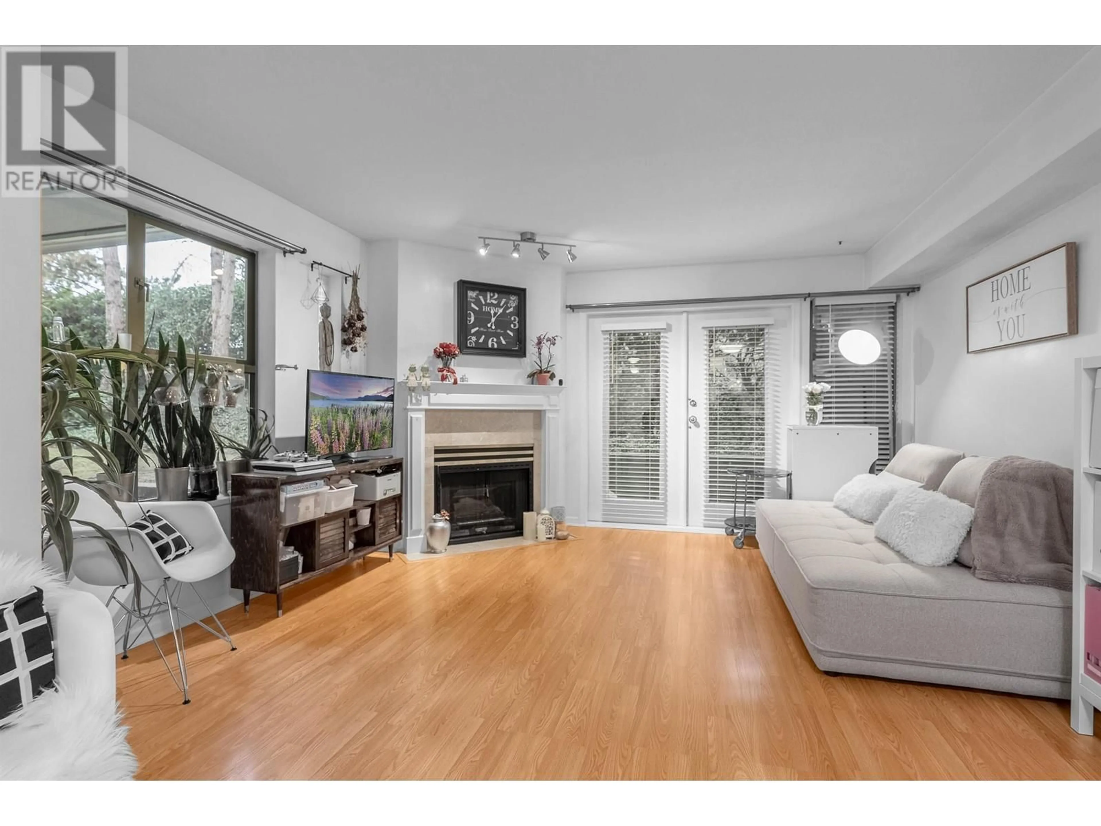 Living room with furniture, wood/laminate floor for 106A 7025 STRIDE AVENUE, Burnaby British Columbia V3N4Y1