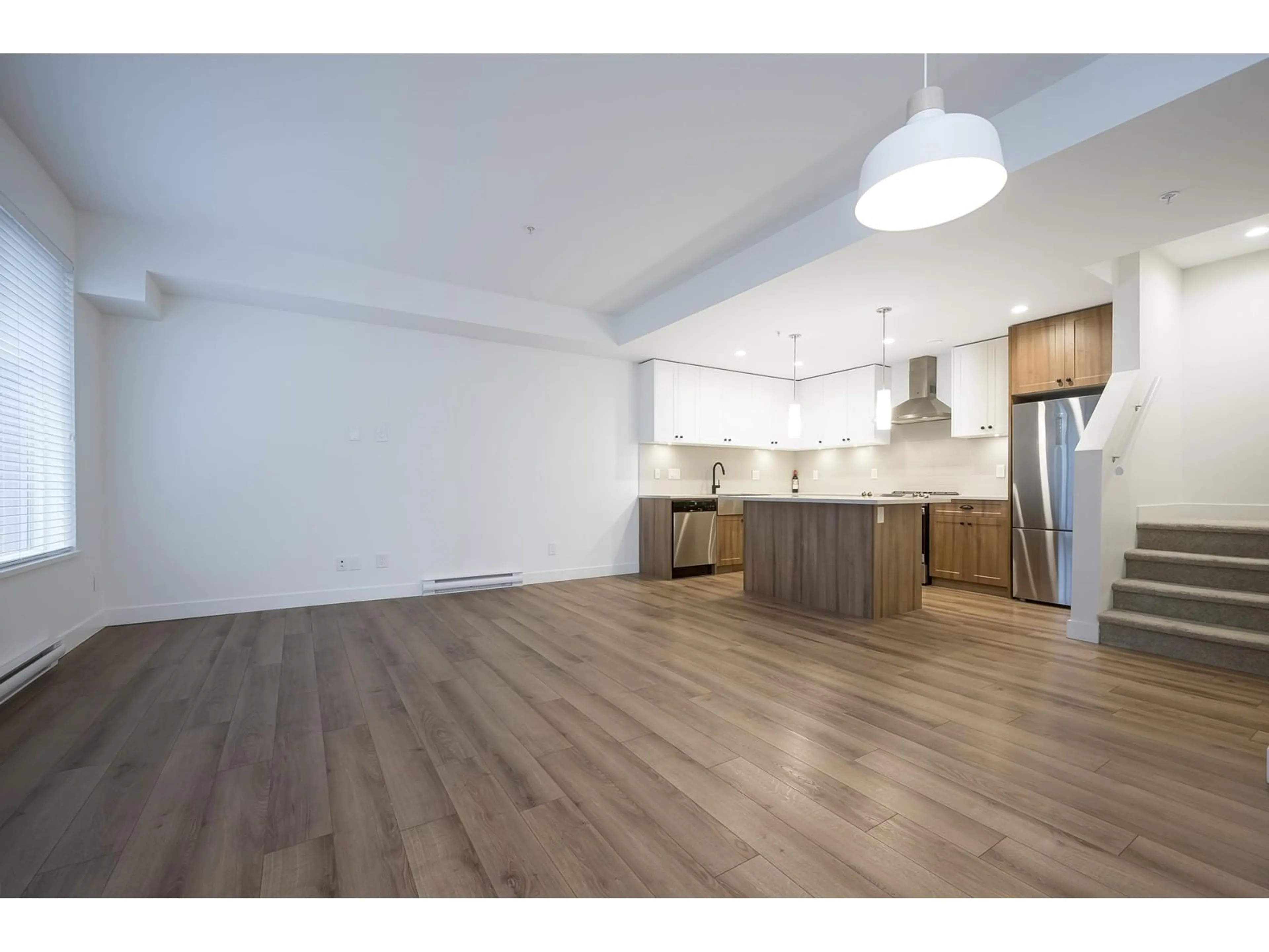 Open concept kitchen, wood/laminate floor for 66 - 20487 65, Langley British Columbia V2Y3K8