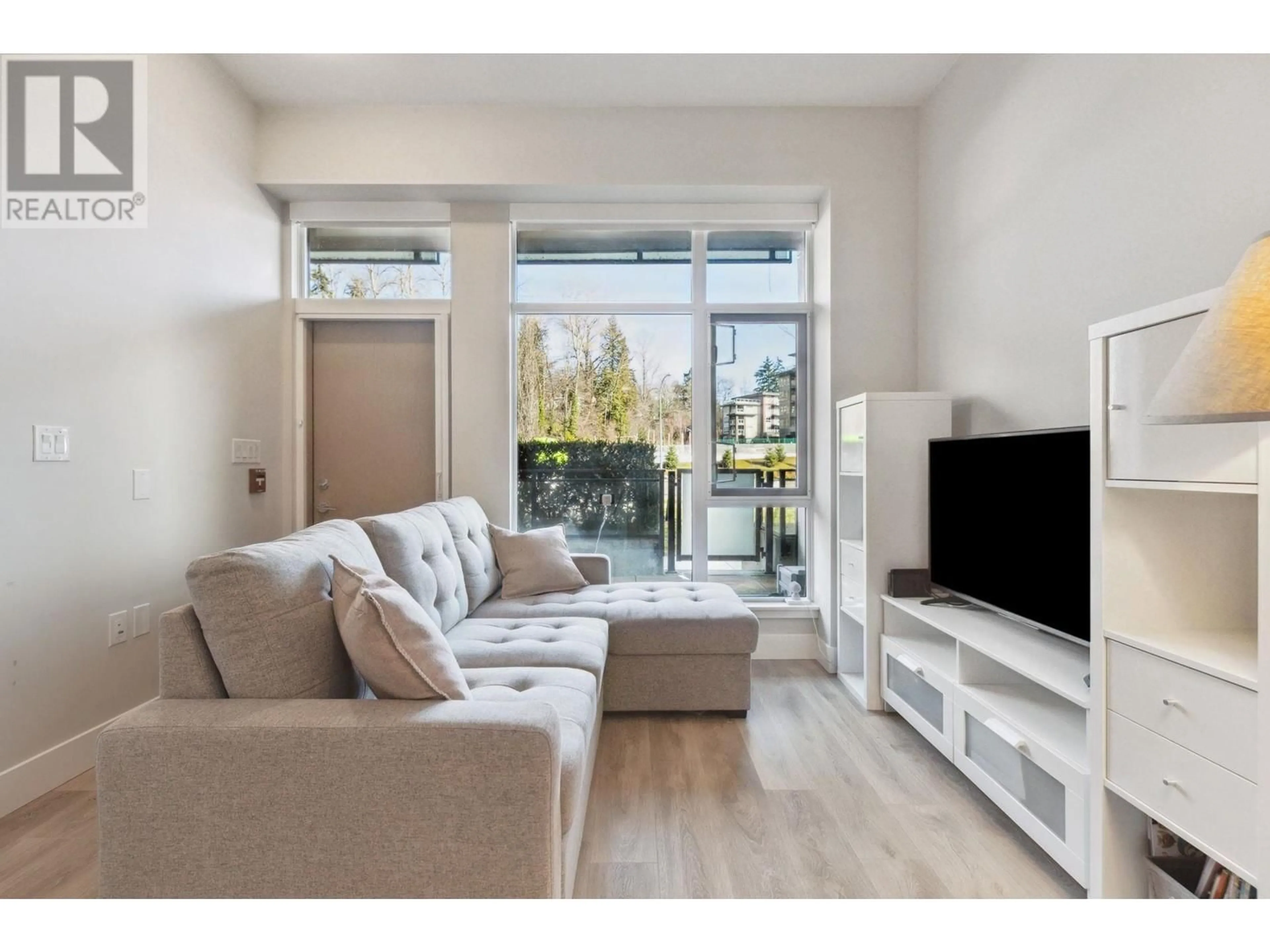 Living room with furniture, wood/laminate floor for 101 3588 SAWMILL CRESCENT, Vancouver British Columbia V5S0H5