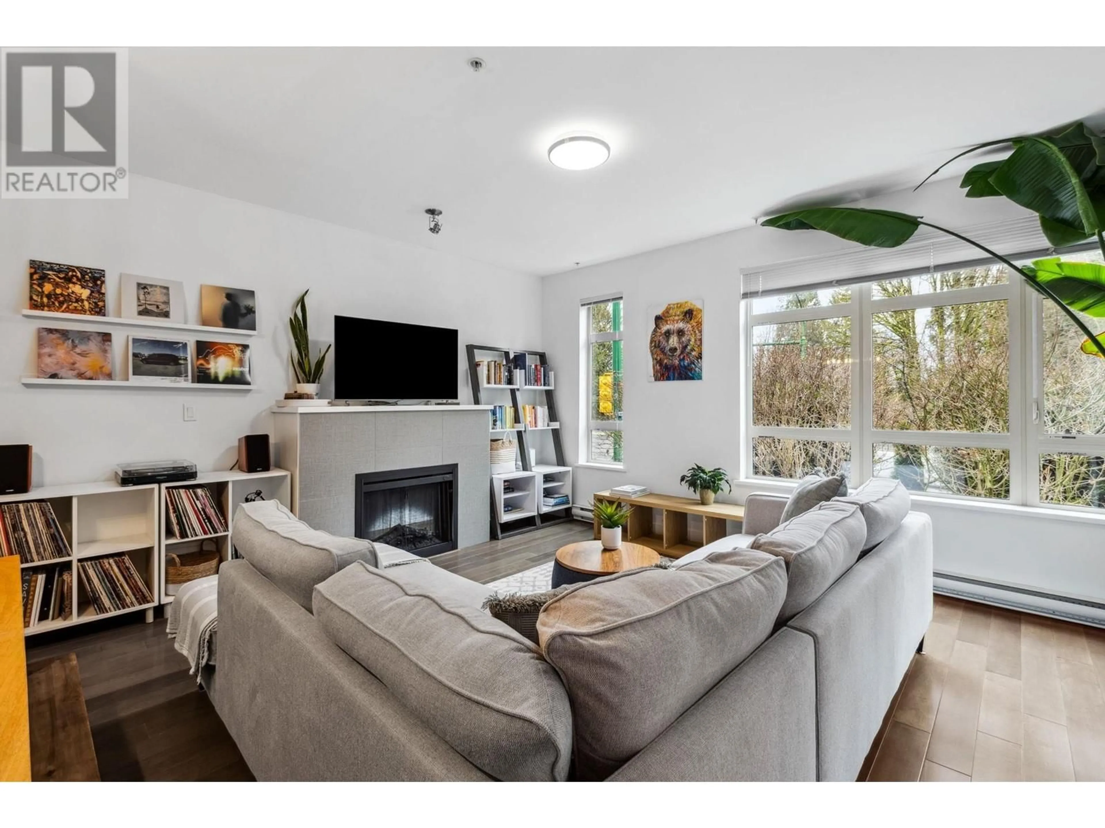 Living room with furniture, wood/laminate floor for 107 3294 MT SEYMOUR PARKWAY, North Vancouver British Columbia V7H0B1