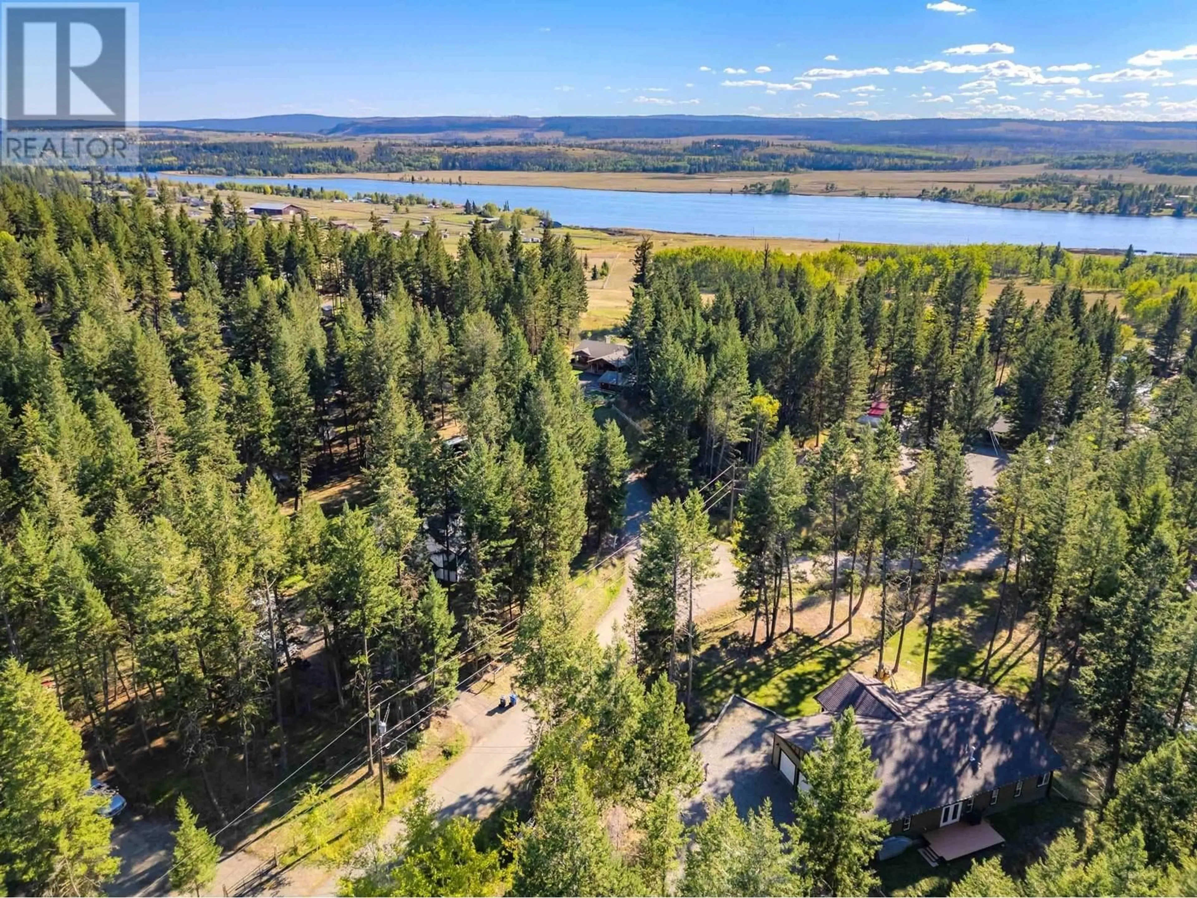 A pic from outside/outdoor area/front of a property/back of a property/a pic from drone, forest/trees view for 5065 KINNCUM ROAD, 108 Mile Ranch British Columbia V0K2Z0