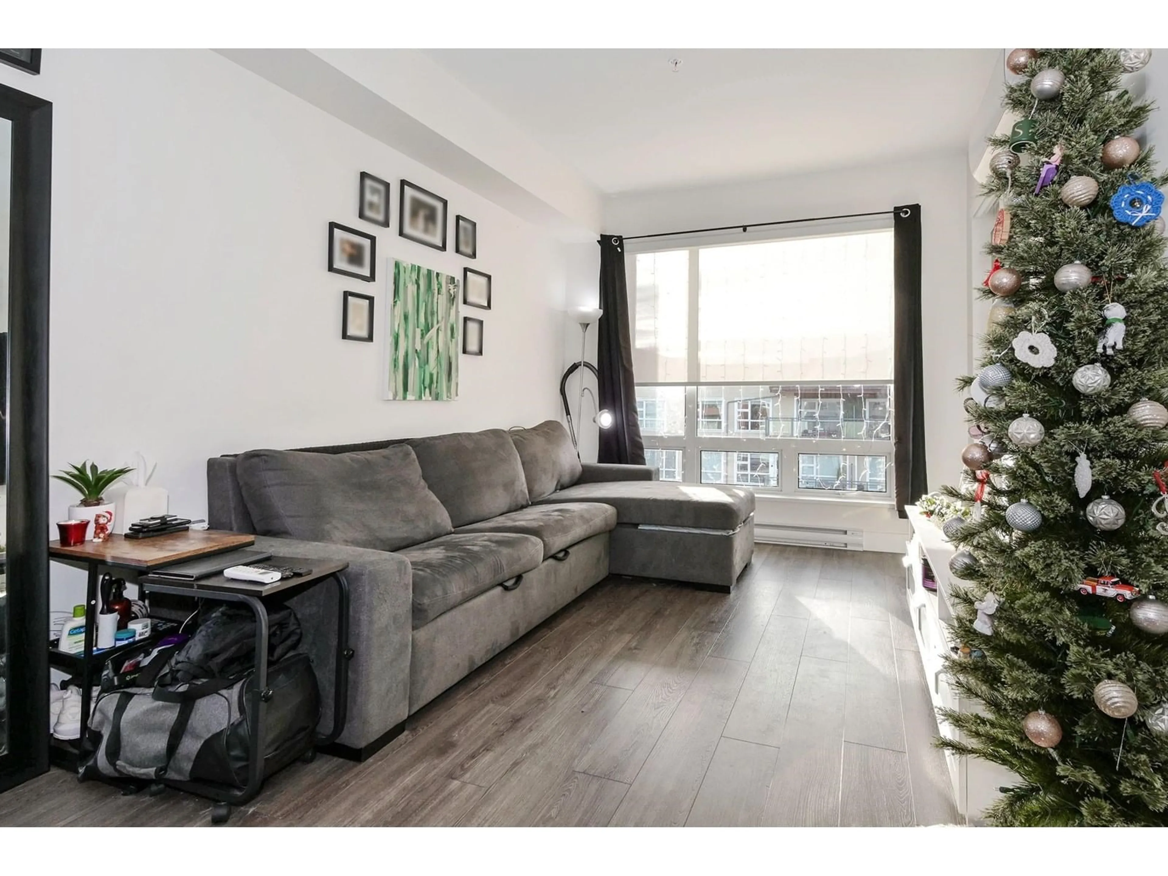 Living room with furniture, wood/laminate floor for A414 - 20727 WILLOUGHBY TOWN CENTRE, Langley British Columbia V2Y3N1
