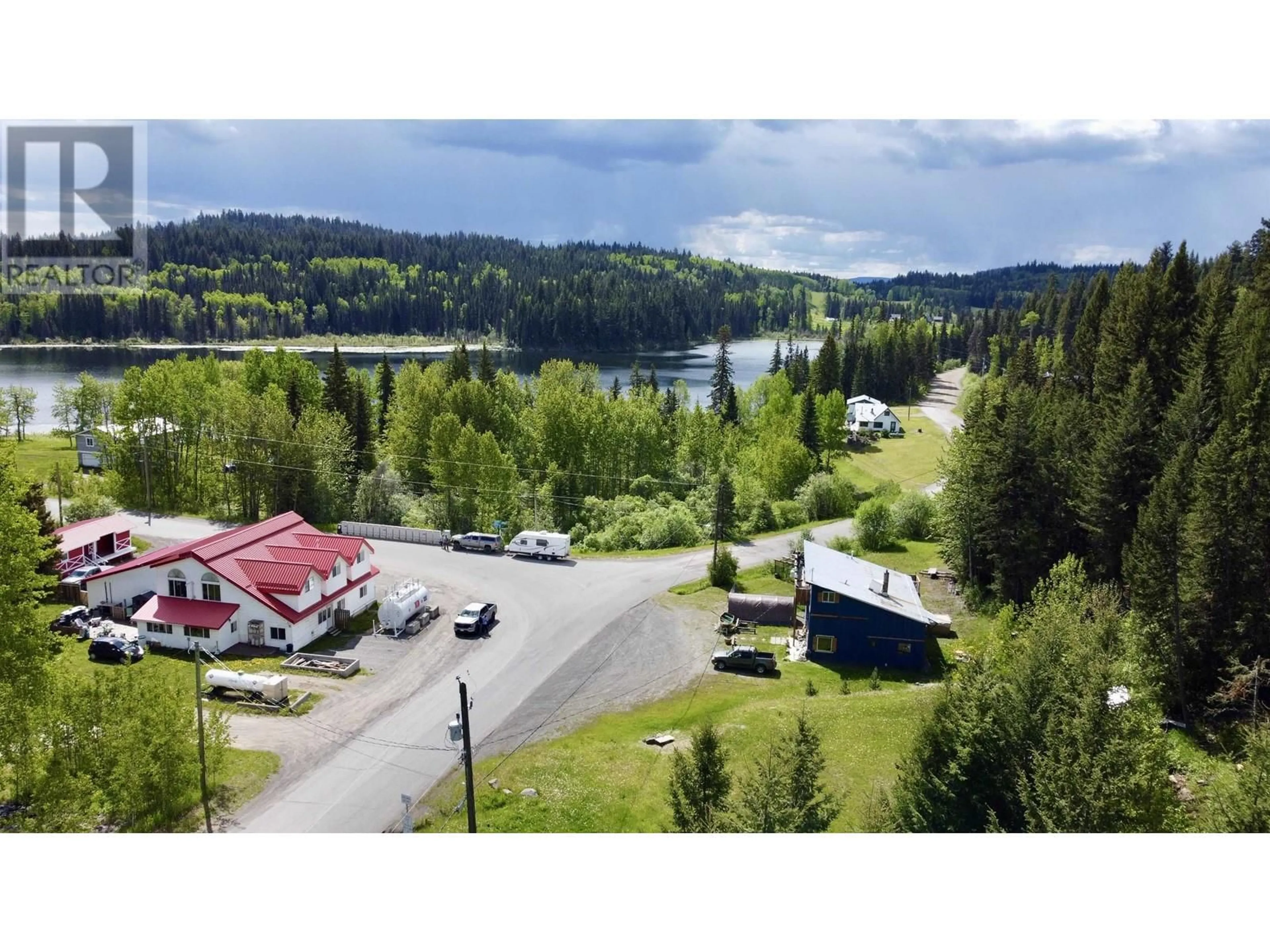 A pic from outside/outdoor area/front of a property/back of a property/a pic from drone, water/lake/river/ocean view for 7554 BRIDGE LAKE BUSINESS RTE, Bridge Lake British Columbia V0K1E0