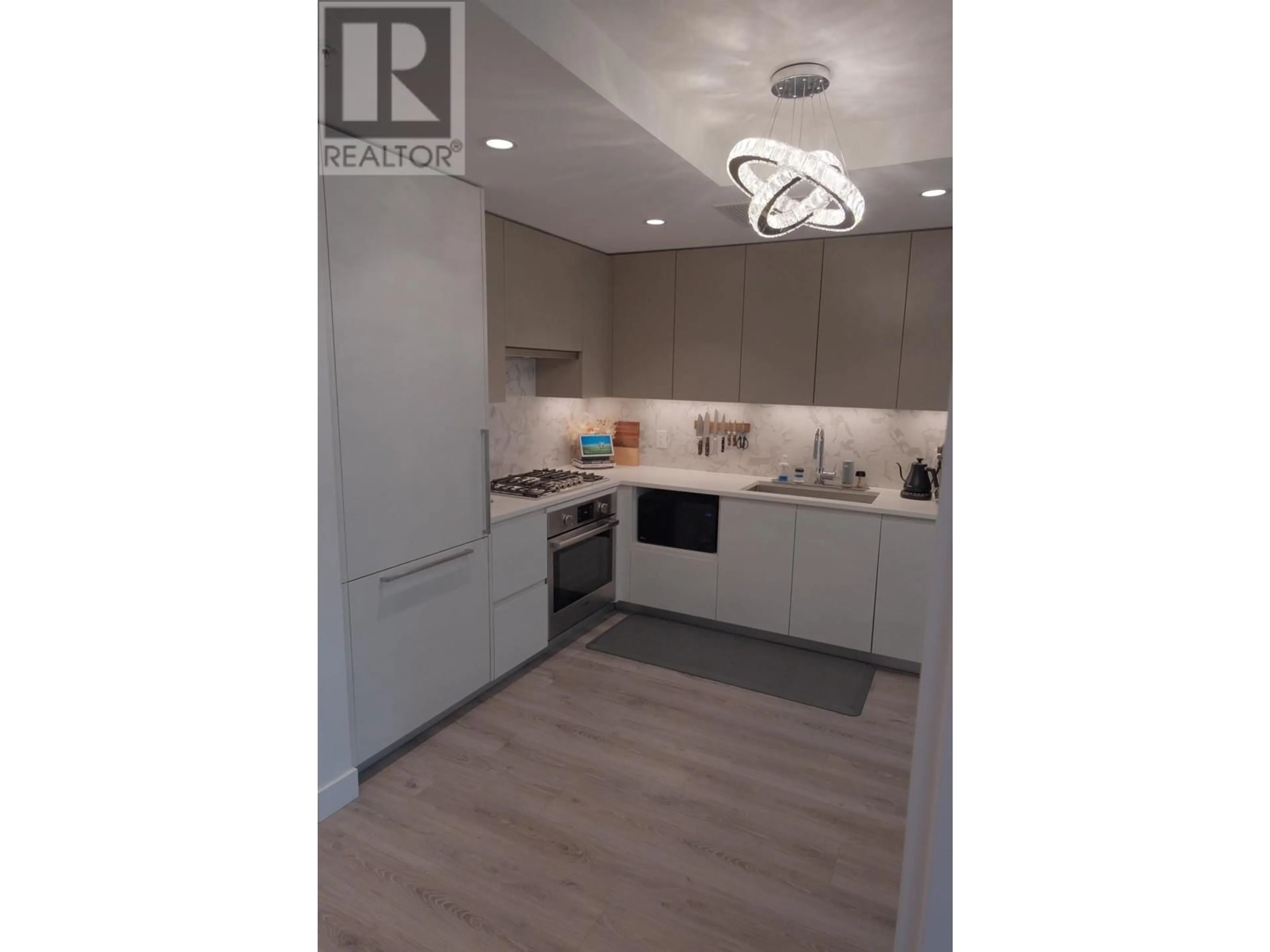 Open concept kitchen, wood/laminate floor for 214 - 8181 CHESTER STREET, Vancouver British Columbia V5X0J9