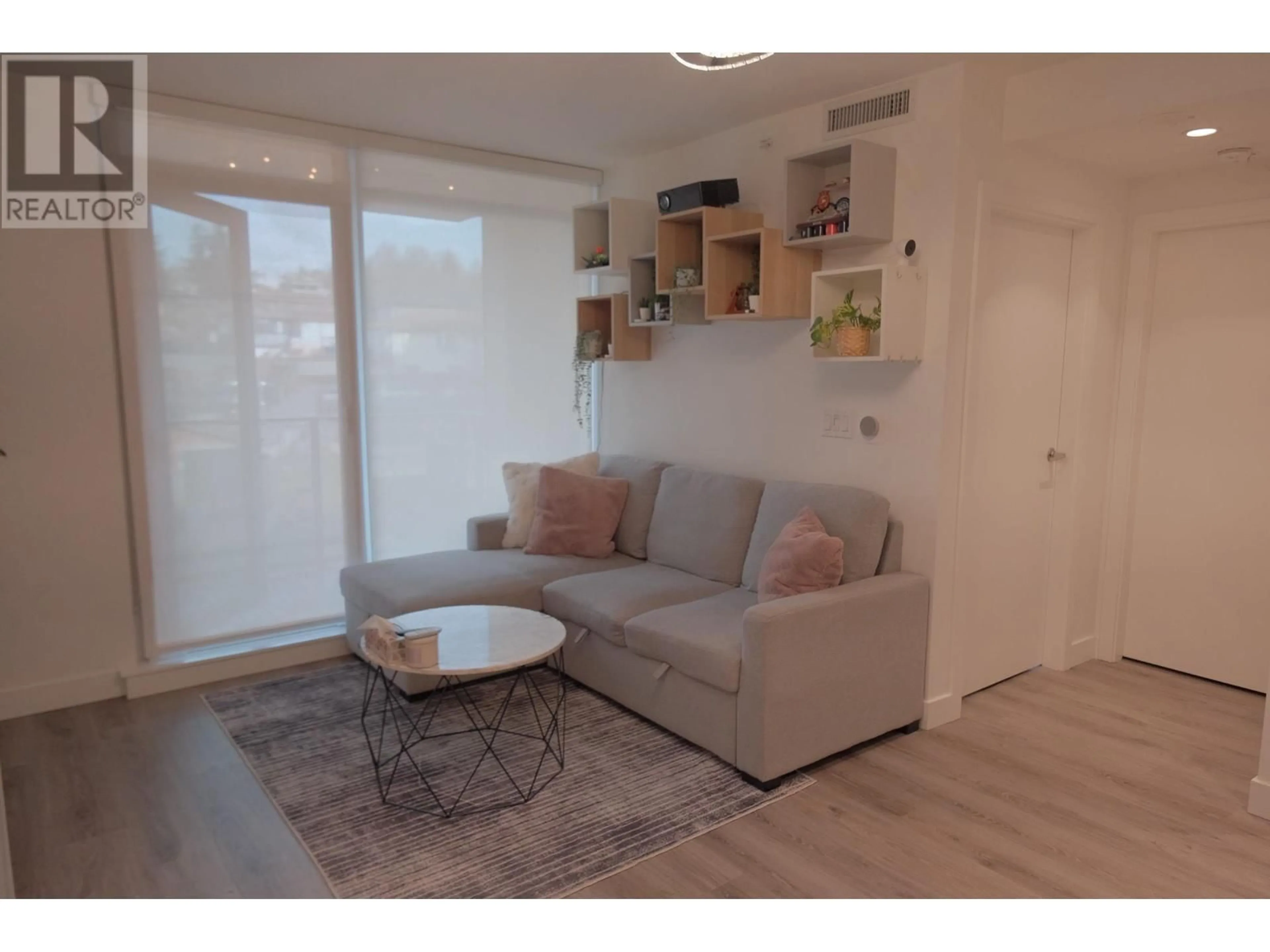 Living room with furniture, wood/laminate floor for 214 8181 CHESTER STREET, Vancouver British Columbia V5X0J9