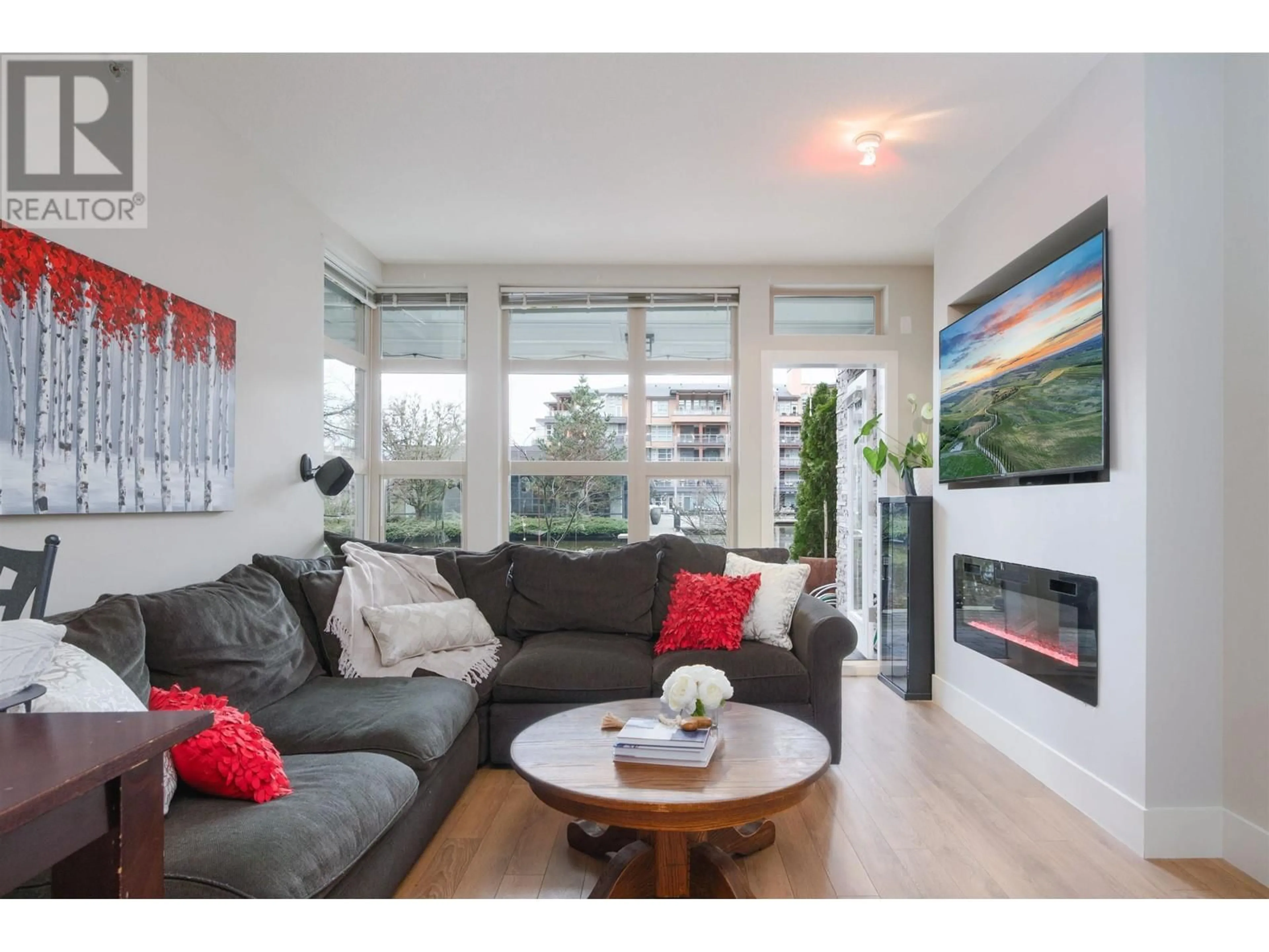 Living room with furniture, wood/laminate floor for 115 3606 ALDERCREST DRIVE, North Vancouver British Columbia V7G0A3