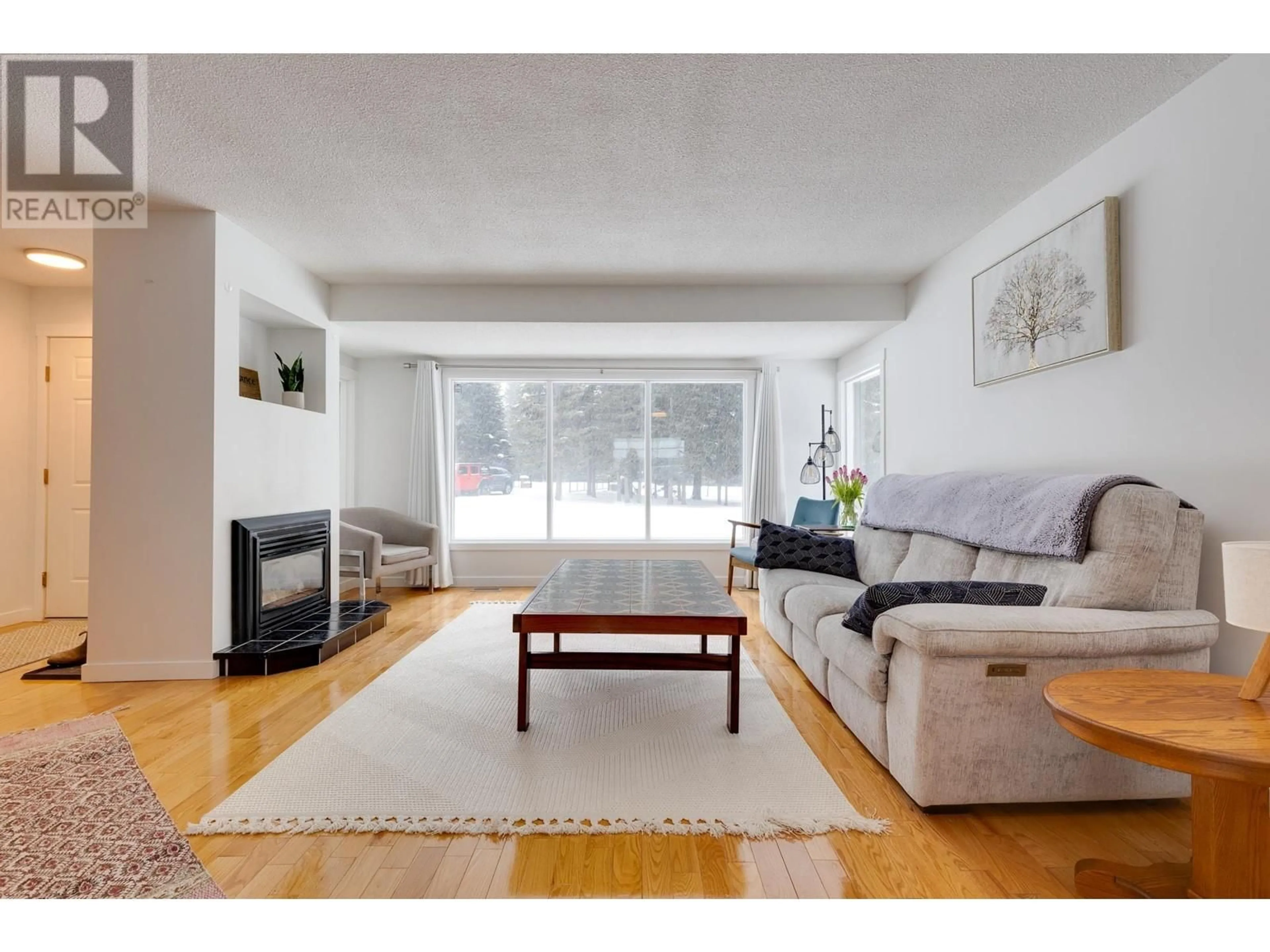 Living room with furniture, wood/laminate floor for 3955 SUNSHINE CRESCENT, Prince George British Columbia V2N5Y2