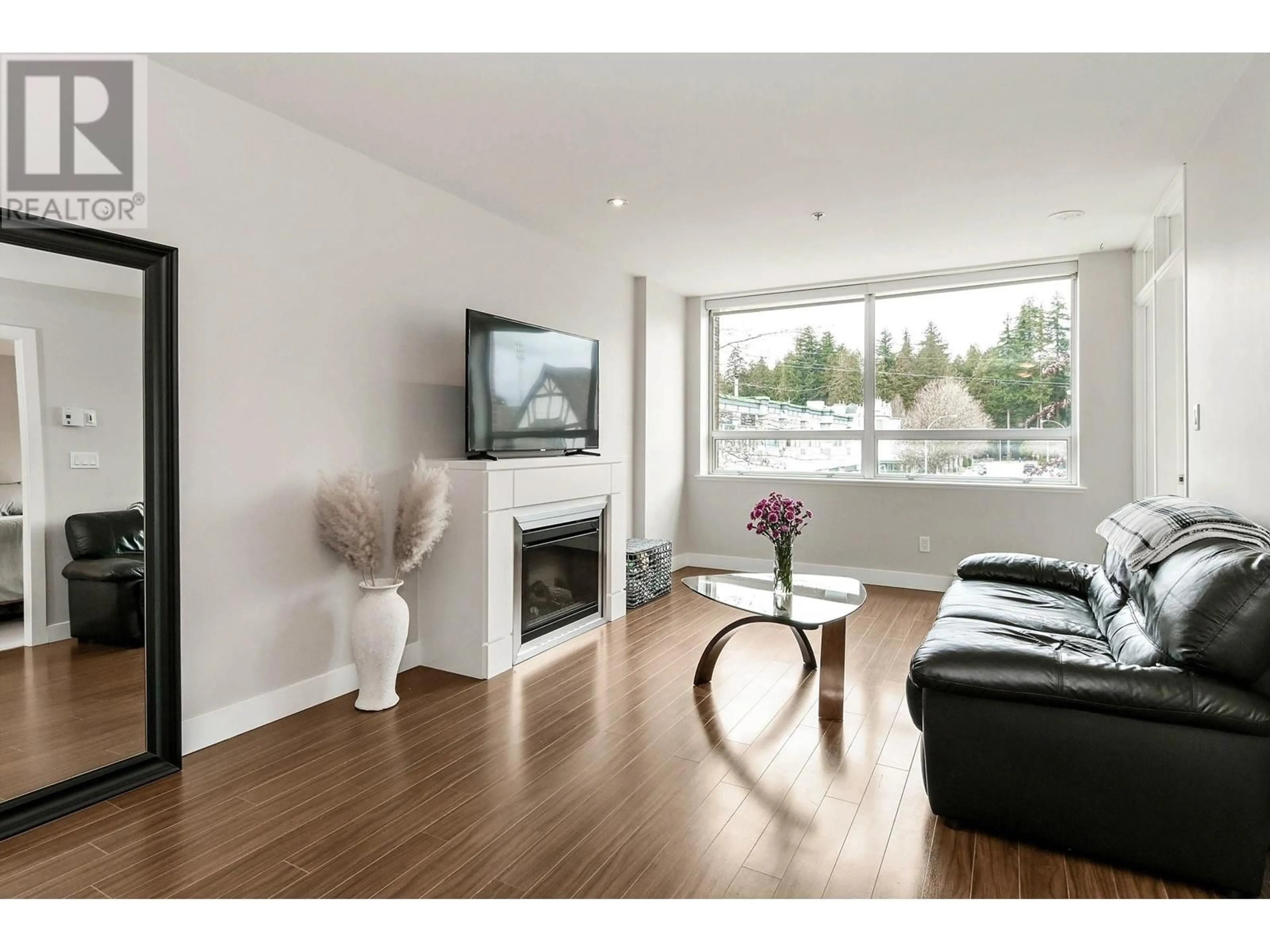 Living room with furniture, wood/laminate floor for 202 12069 HARRIS ROAD, Pitt Meadows British Columbia V3Y0C8