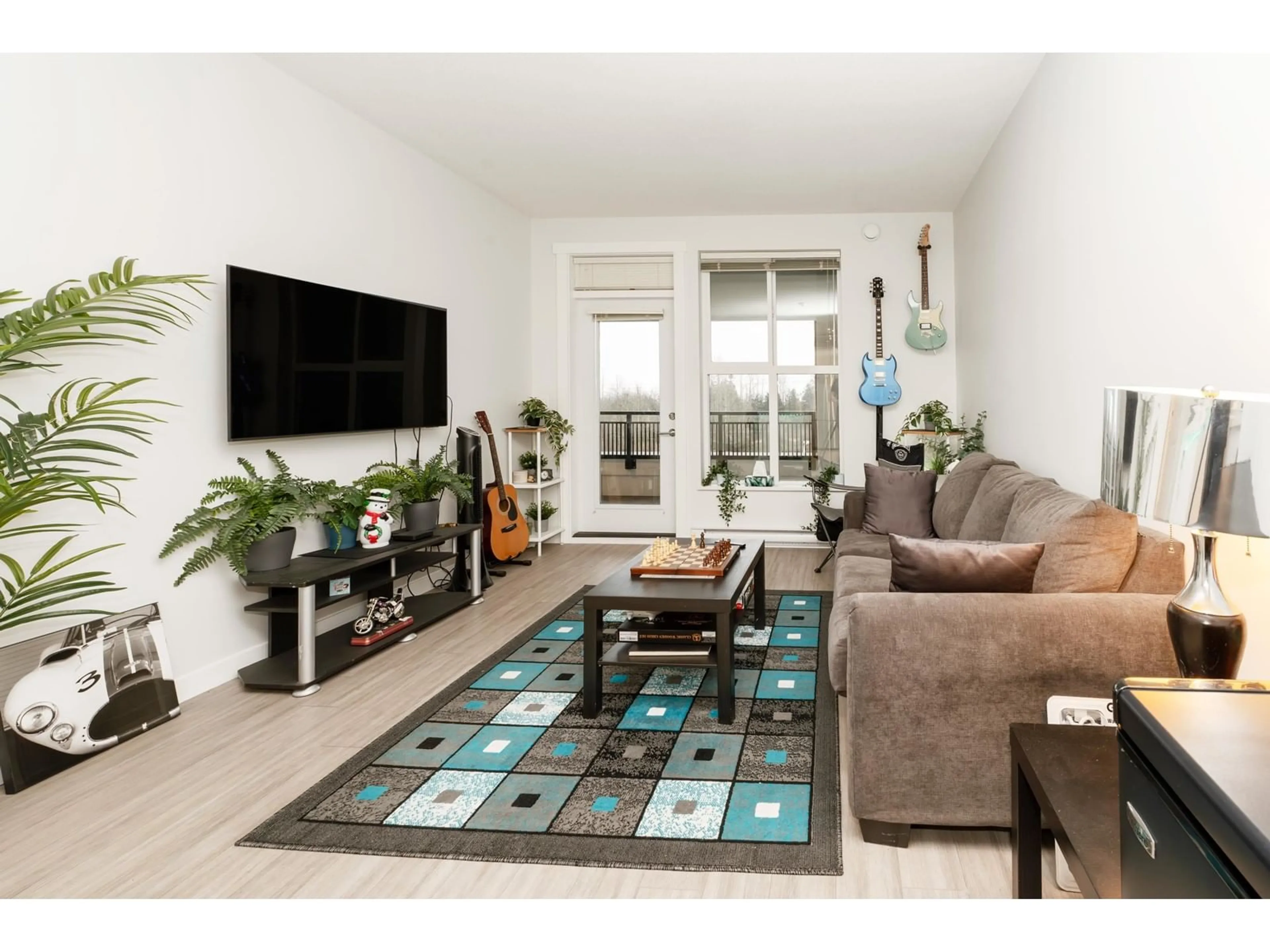 Living room with furniture, wood/laminate floor for C414 8150 207 STREET, Langley British Columbia V2Y4J4