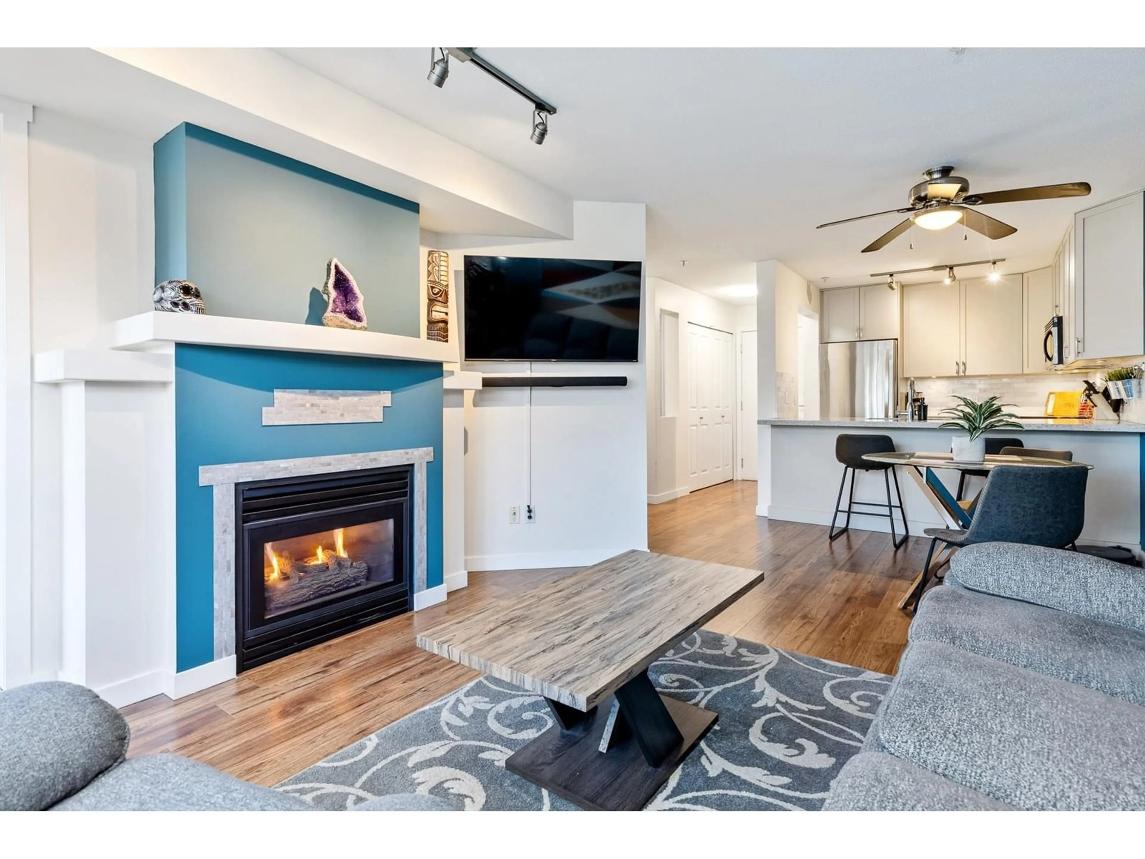 Living room with furniture, wood/laminate floor for 203 19750 64 AVENUE, Langley British Columbia V2T2T1