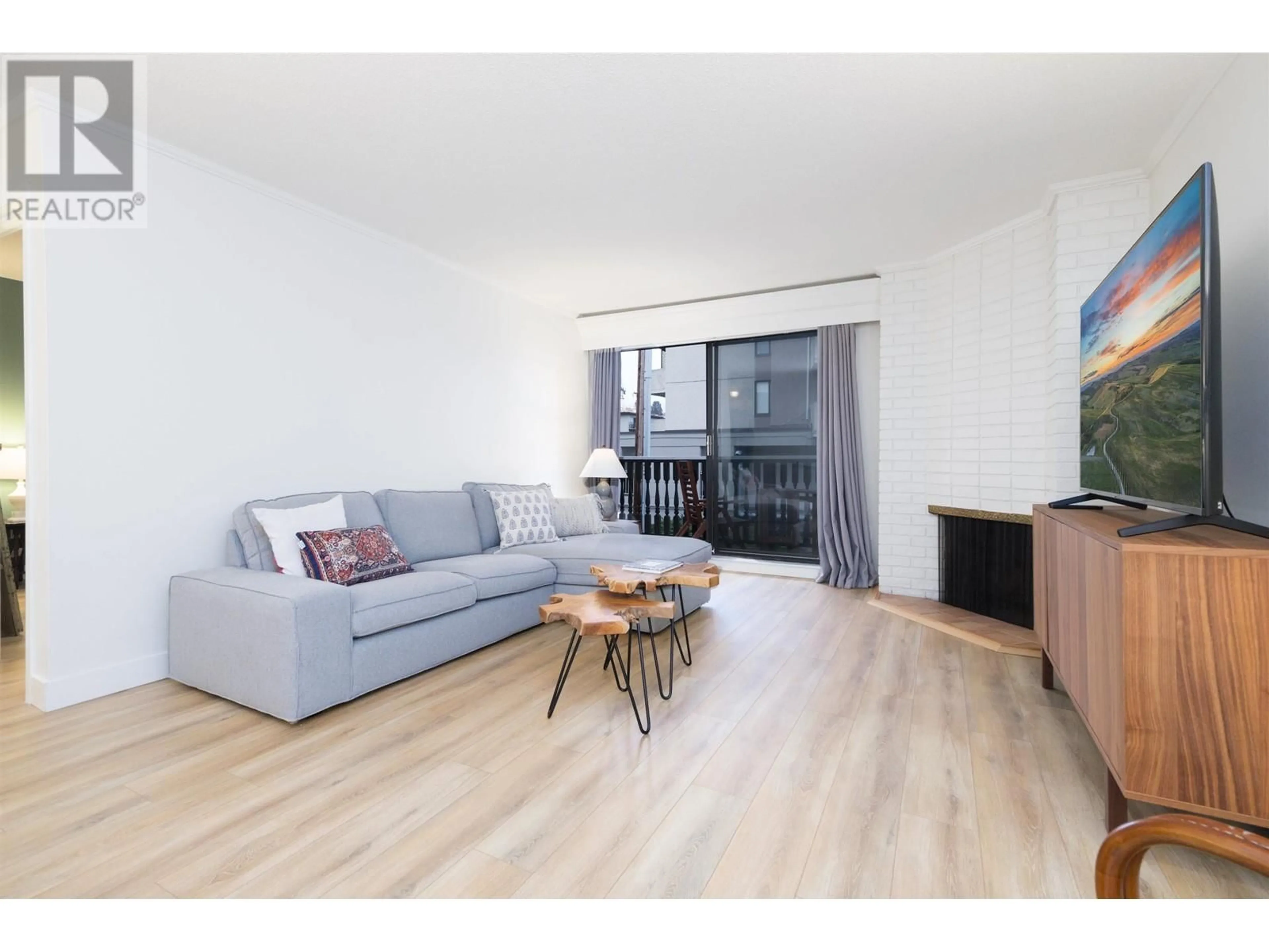 Living room with furniture, wood/laminate floor for 207 1610 CHESTERFIELD AVENUE, North Vancouver British Columbia V7N2N7