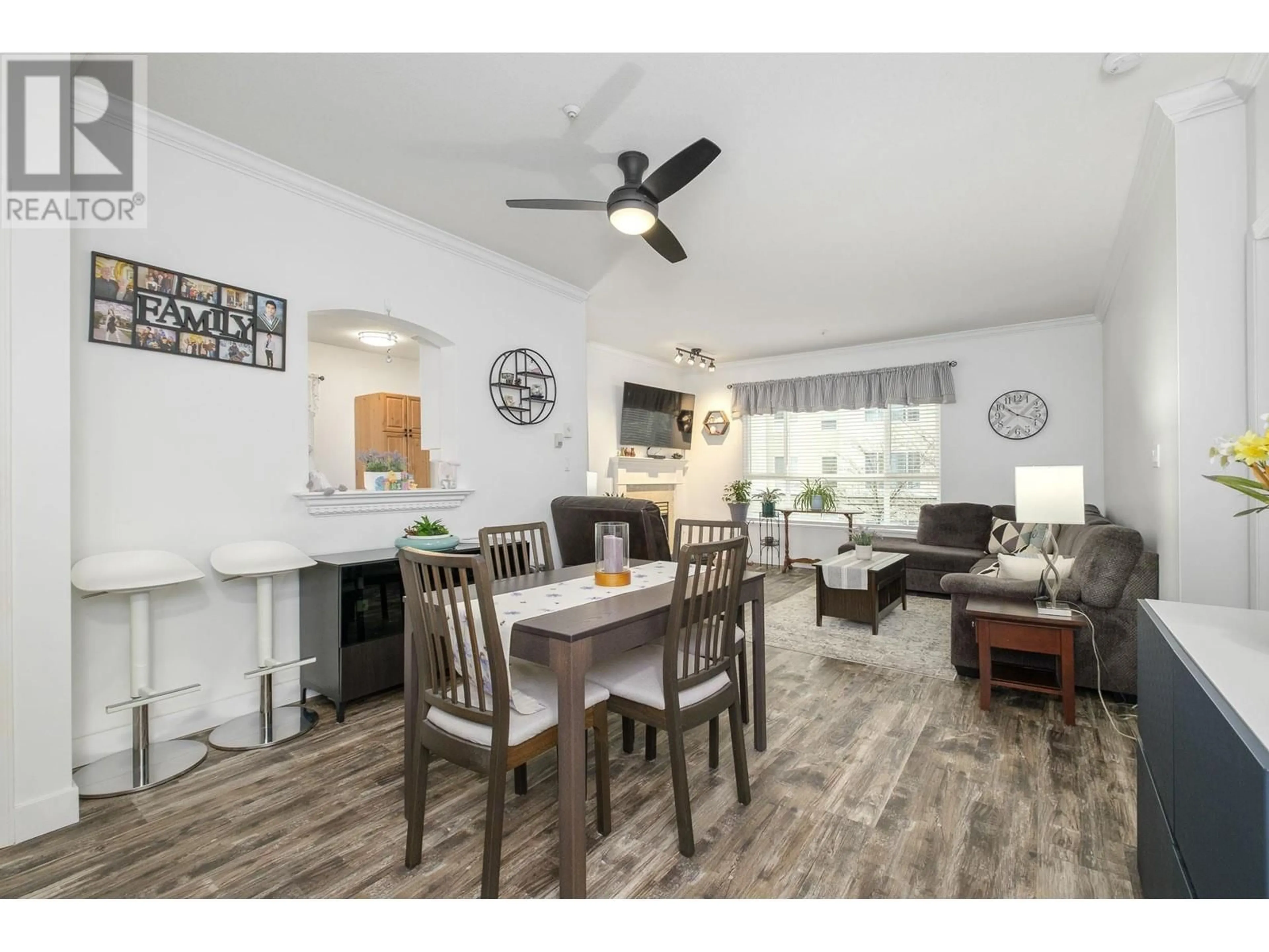 Living room with furniture, wood/laminate floor for 208 3098 GUILDFORD WAY, Coquitlam British Columbia V3B7W8