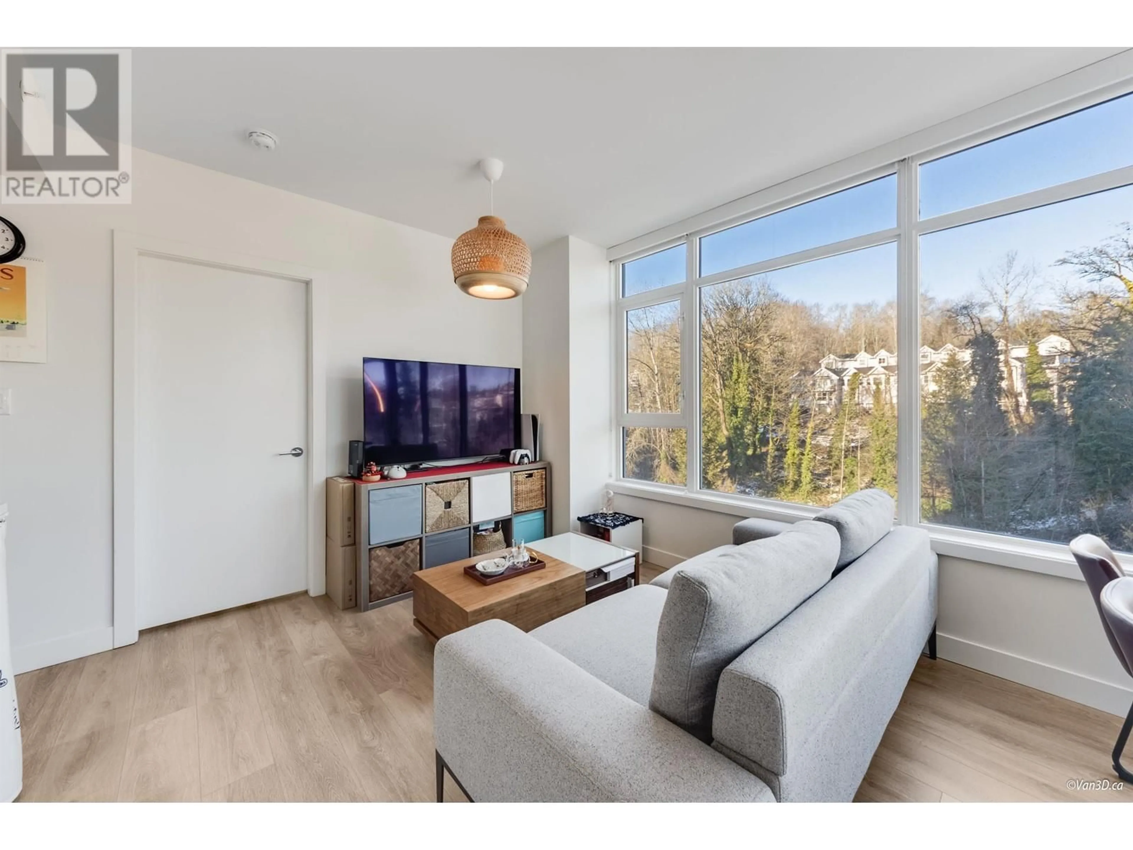 Living room with furniture, wood/laminate floor for 702 - 8538 RIVER DISTRICT CROSSING, Vancouver British Columbia V5S0C9