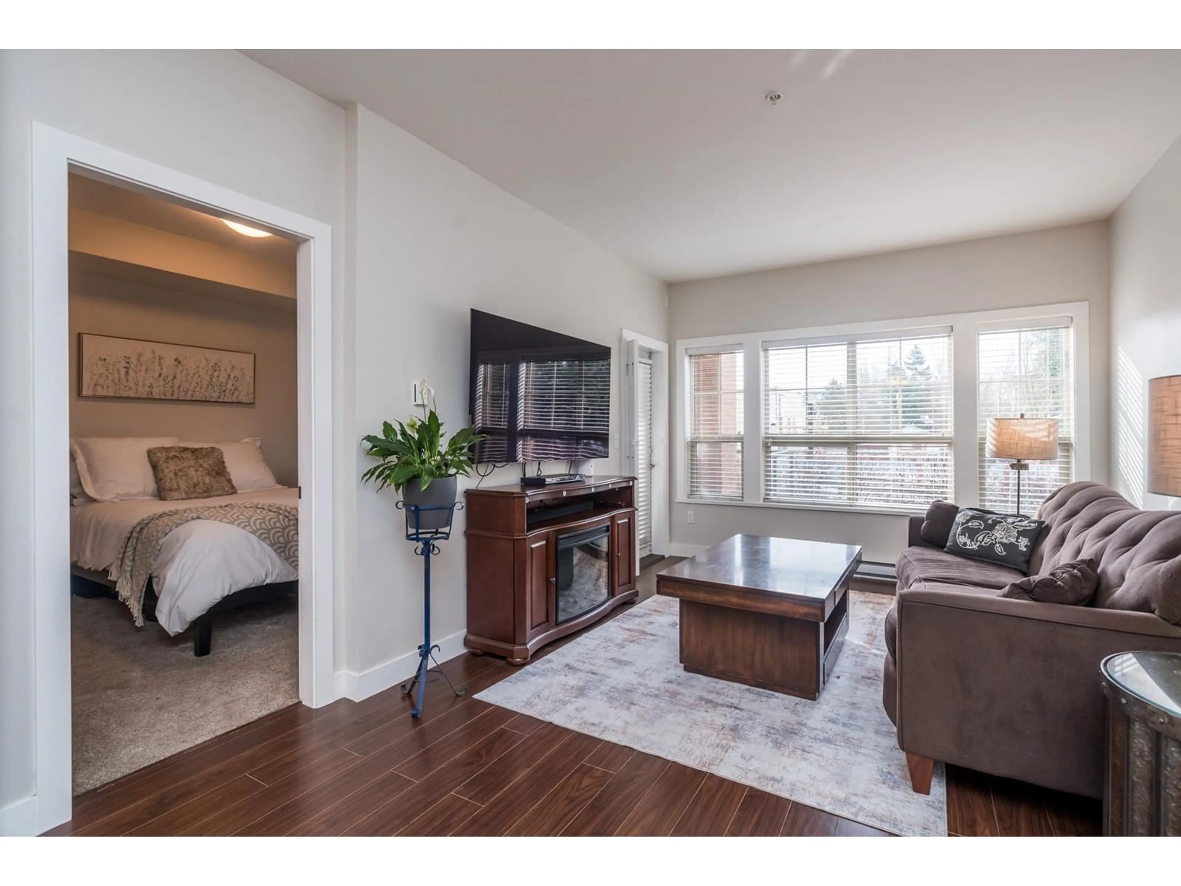 Living room with furniture, wood/laminate floor for 101 20219 54A AVENUE, Langley British Columbia V3A0C7