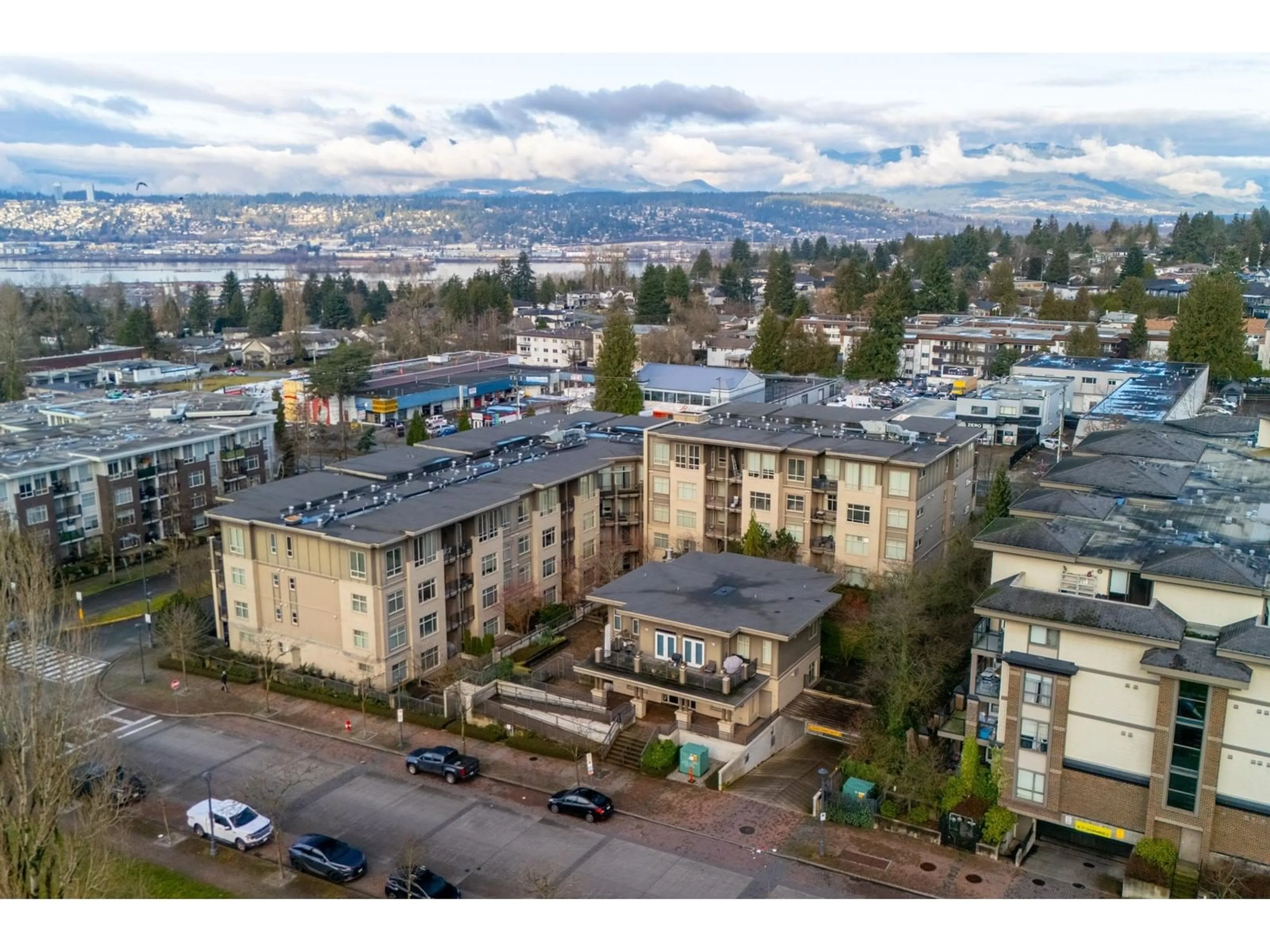 A pic from outside/outdoor area/front of a property/back of a property/a pic from drone, mountain view for 211 13468 KING GEORGE BOULEVARD, Surrey British Columbia V3T0H5