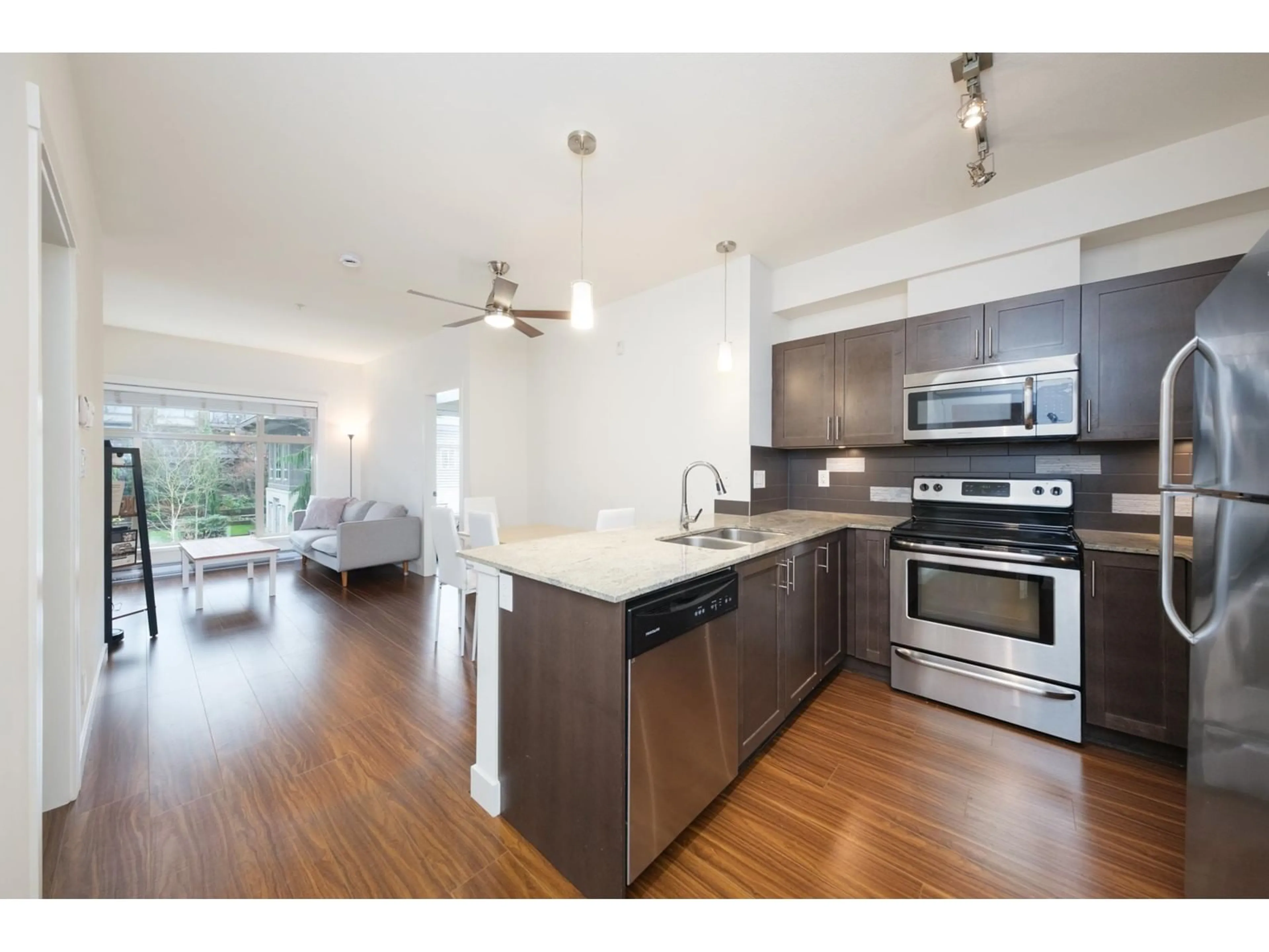 Open concept kitchen, wood/laminate floor for 211 13468 KING GEORGE BOULEVARD, Surrey British Columbia V3T0H5