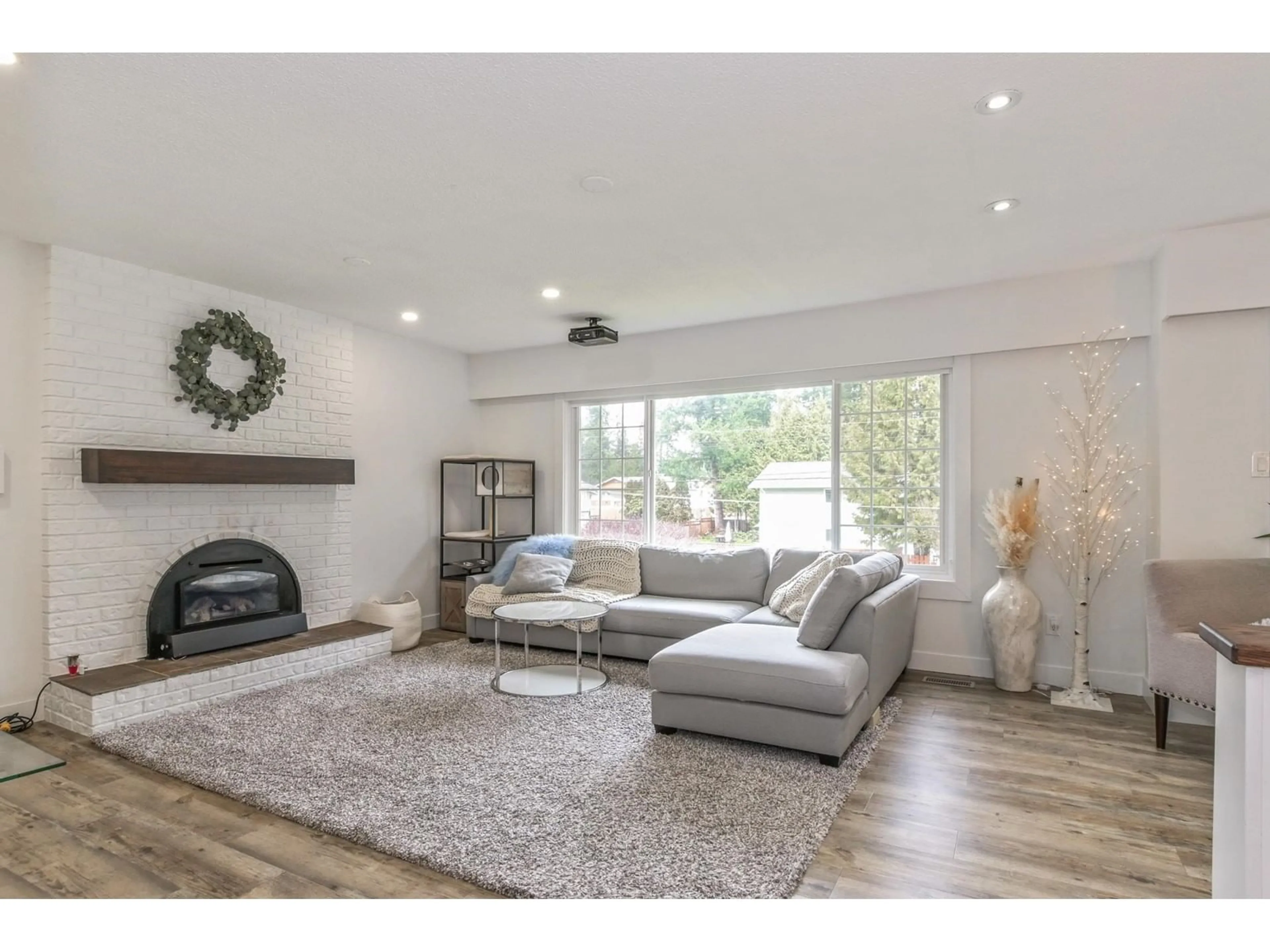 Living room with furniture, wood/laminate floor for 20334 38A AVENUE, Langley British Columbia V3A5M3