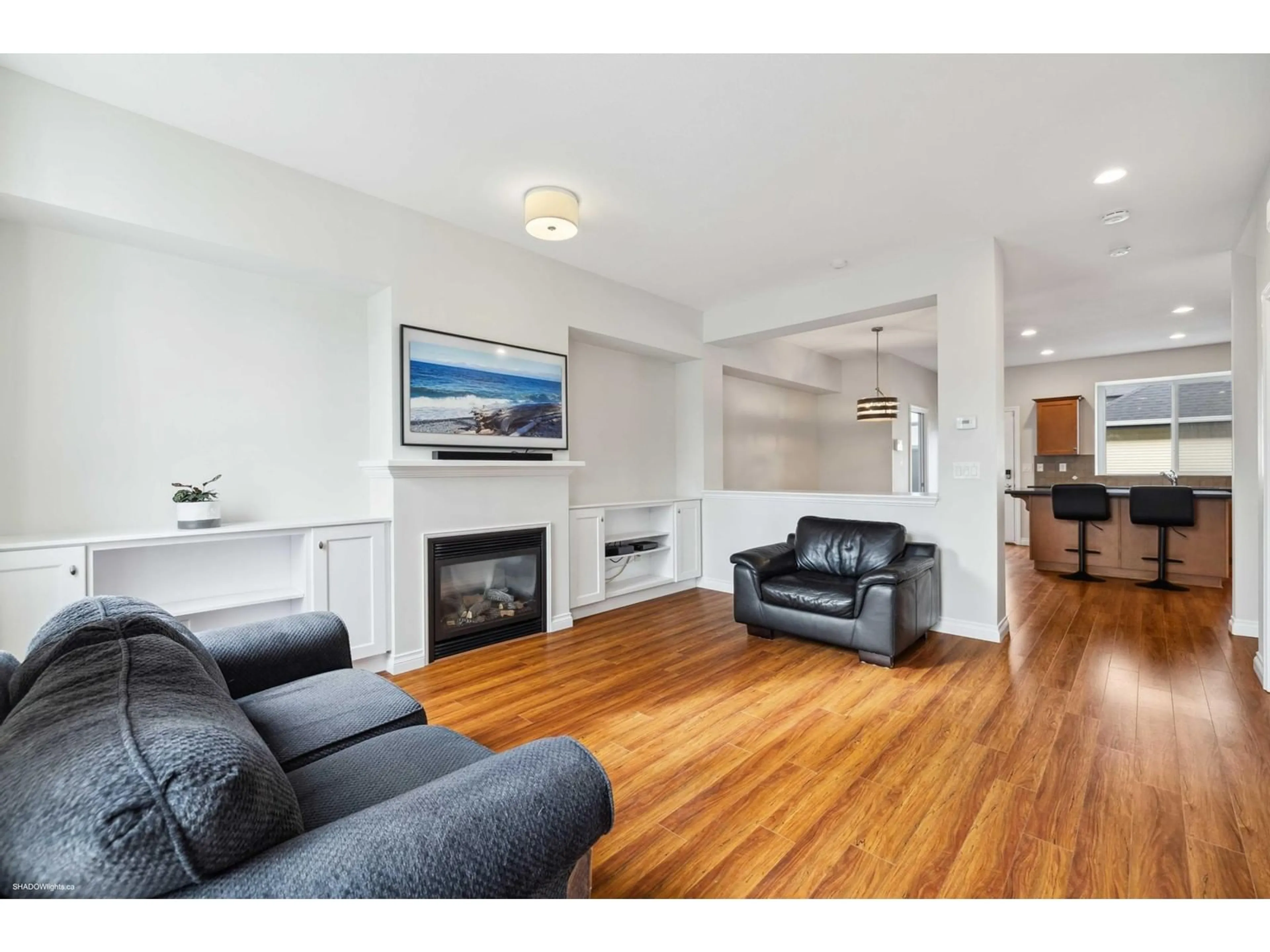 Living room with furniture, wood/laminate floor for 18025 70 AVENUE, Surrey British Columbia V3S6X3