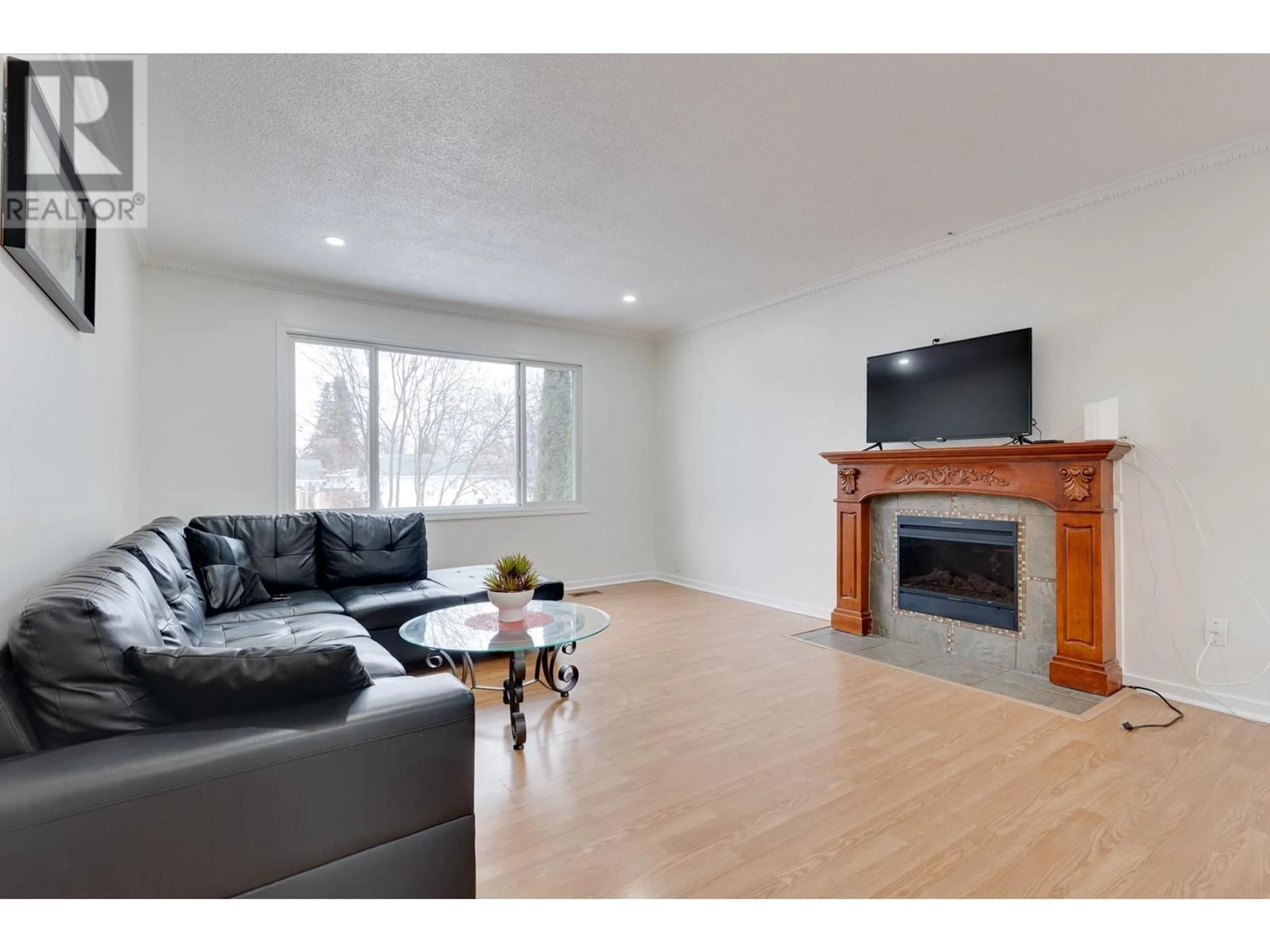 Living room with furniture, wood/laminate floor for 242 FERN CRESCENT, Prince George British Columbia V2N1J6