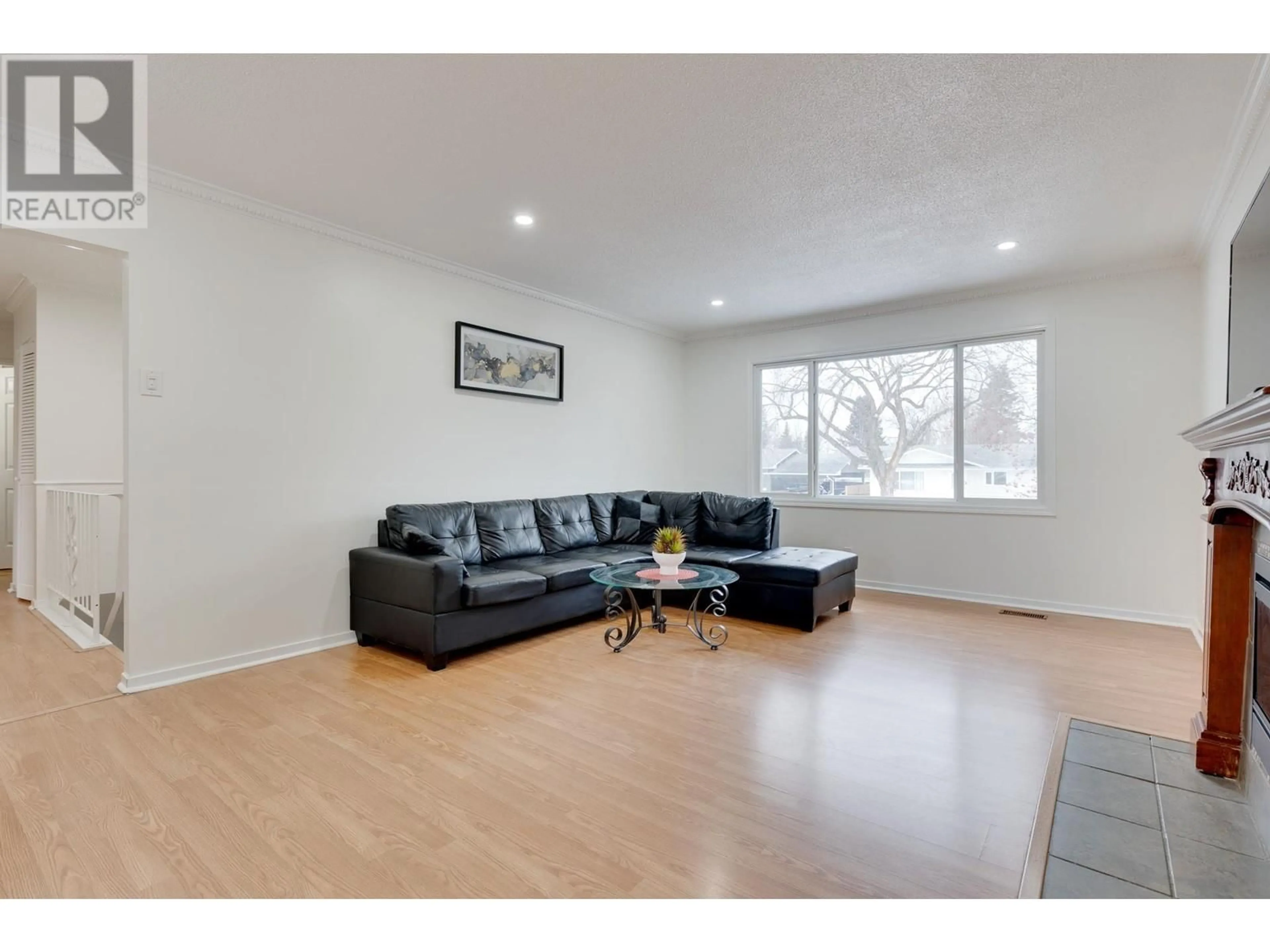 Living room with furniture, wood/laminate floor for 242 FERN CRESCENT, Prince George British Columbia V2N1J6