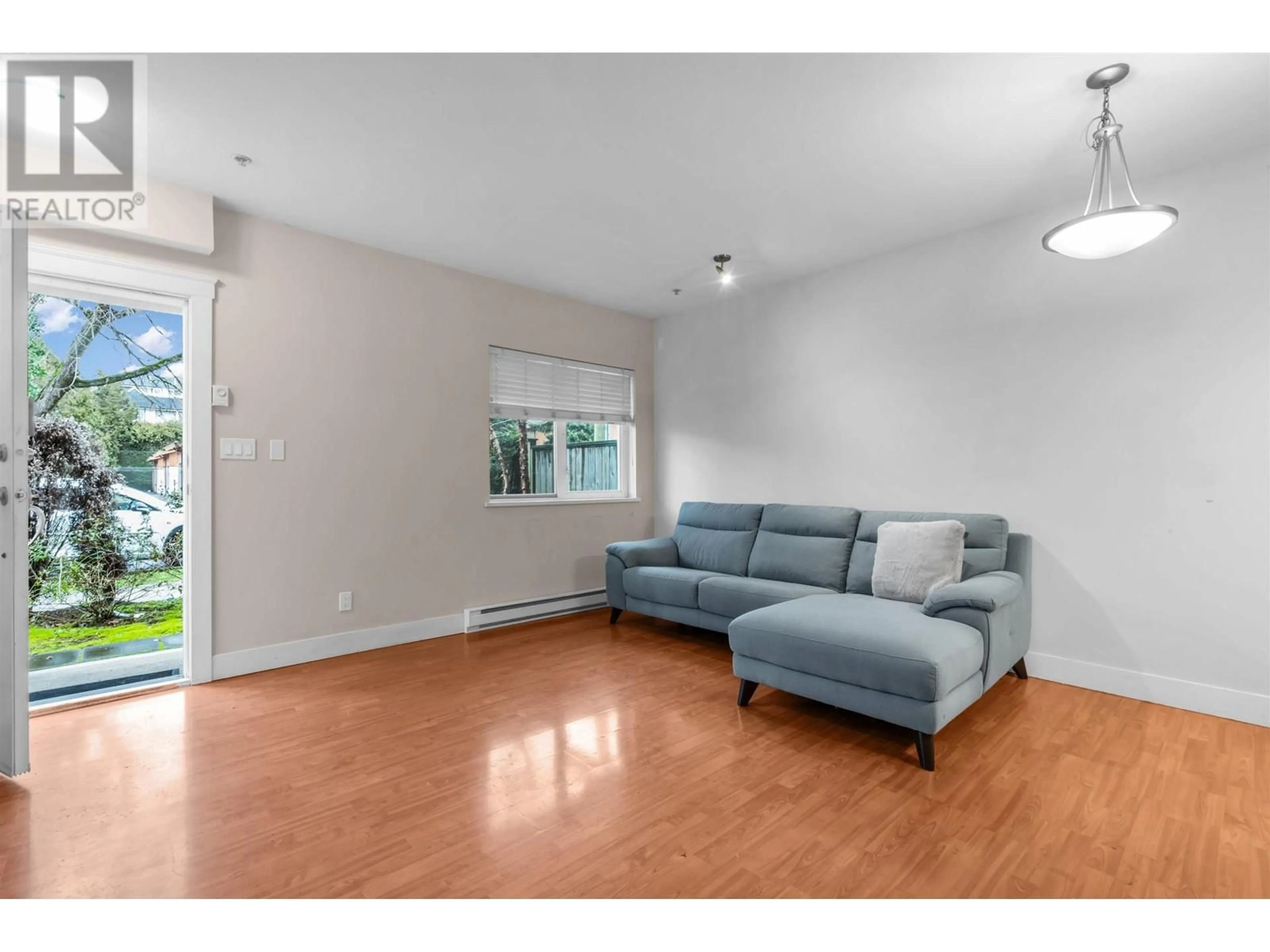 Living room with furniture, wood/laminate floor for 1 8400 COOK ROAD, Richmond British Columbia V6Y1V5