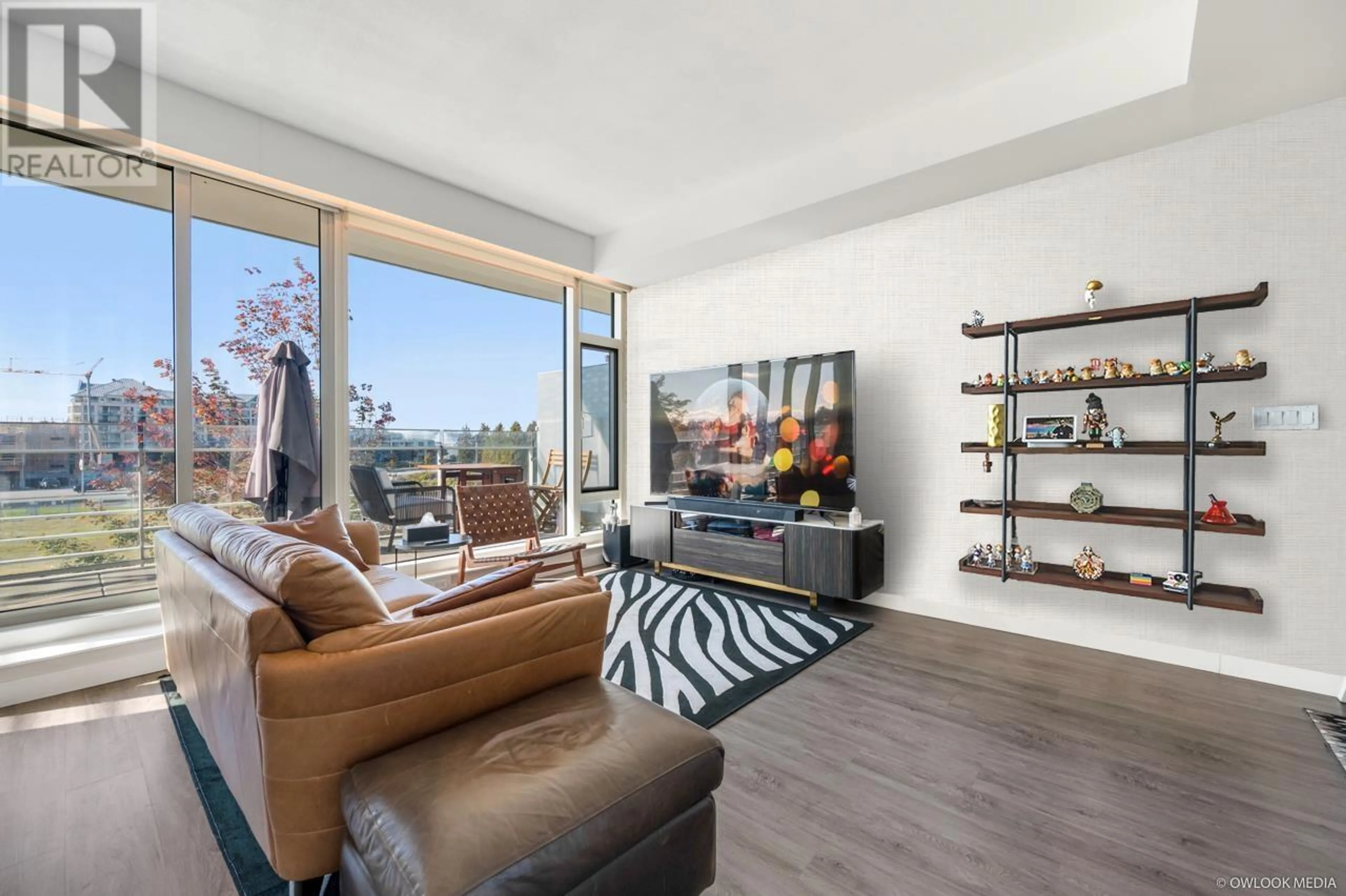 Living room with furniture, wood/laminate floor for 309 - 5177 BRIGHOUSE WAY, Richmond British Columbia V7C0A7