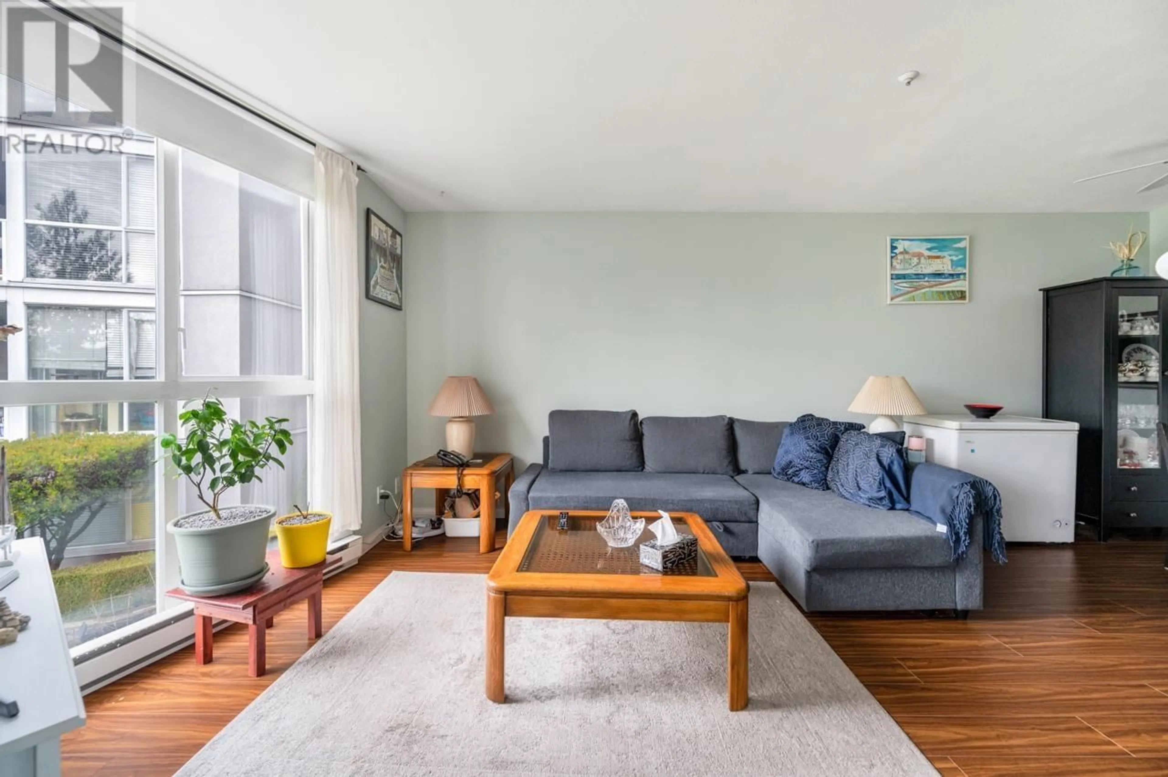 Living room with furniture, wood/laminate floor for 208 8450 JELLICOE STREET, Vancouver British Columbia V5S4S9