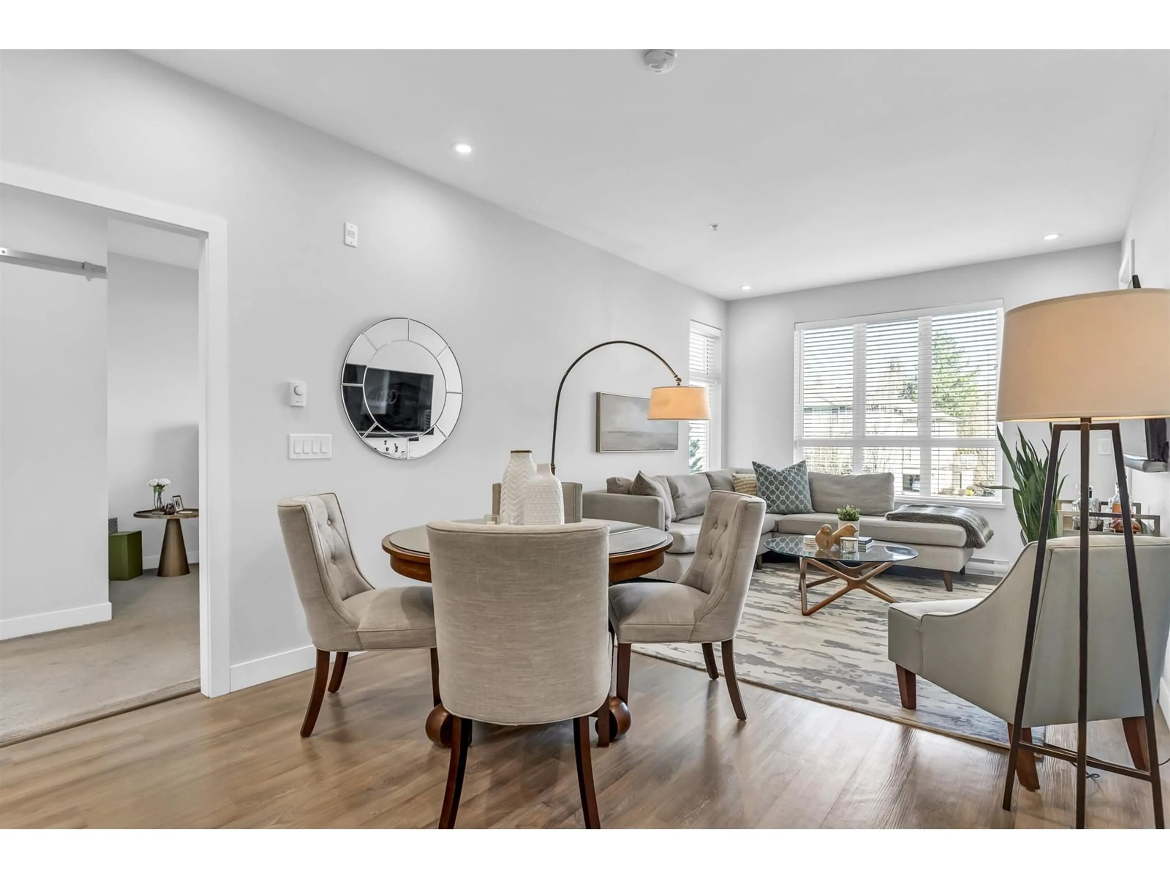 Living room with furniture, wood/laminate floor for 312 - 15436 31, Surrey British Columbia V3Z1H3