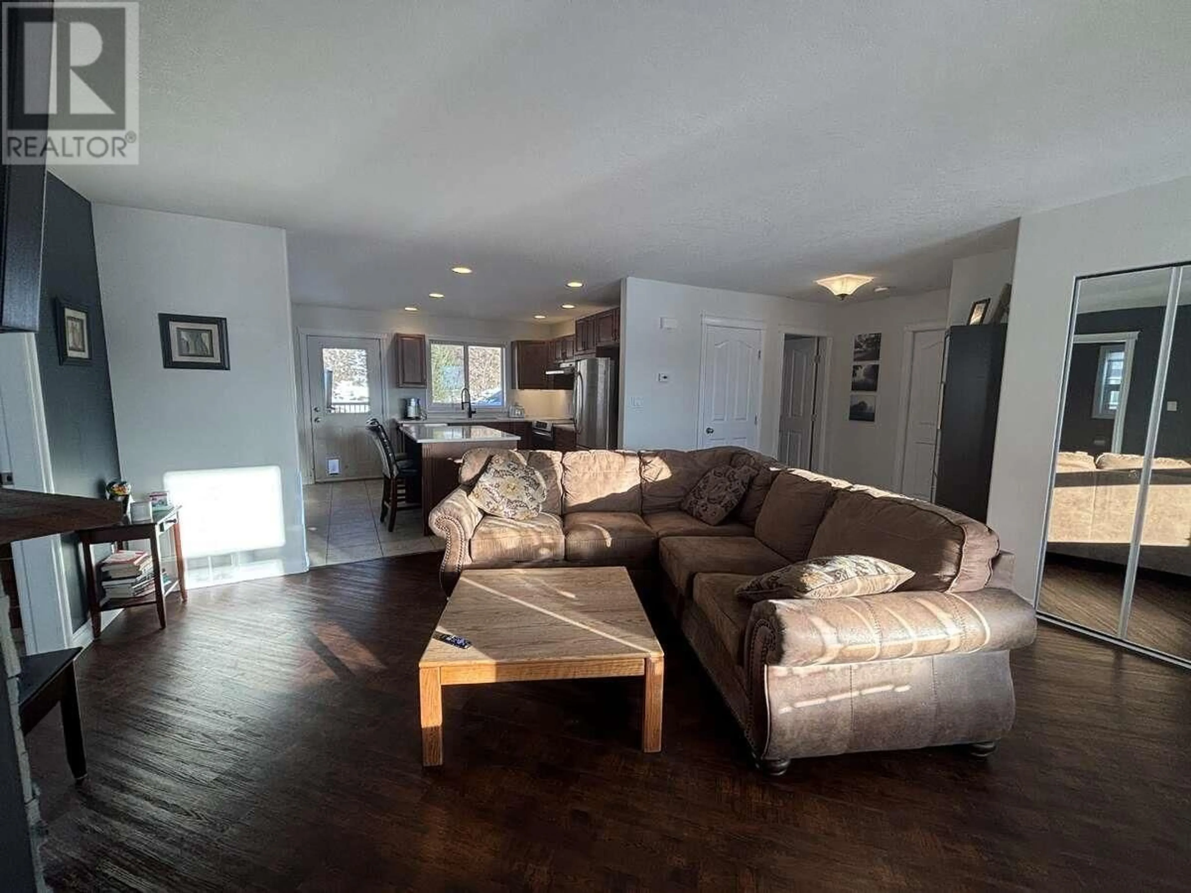 Living room with furniture, wood/laminate floor for 211 NICKEL RIDGE AVENUE, Quesnel British Columbia V2J6P6