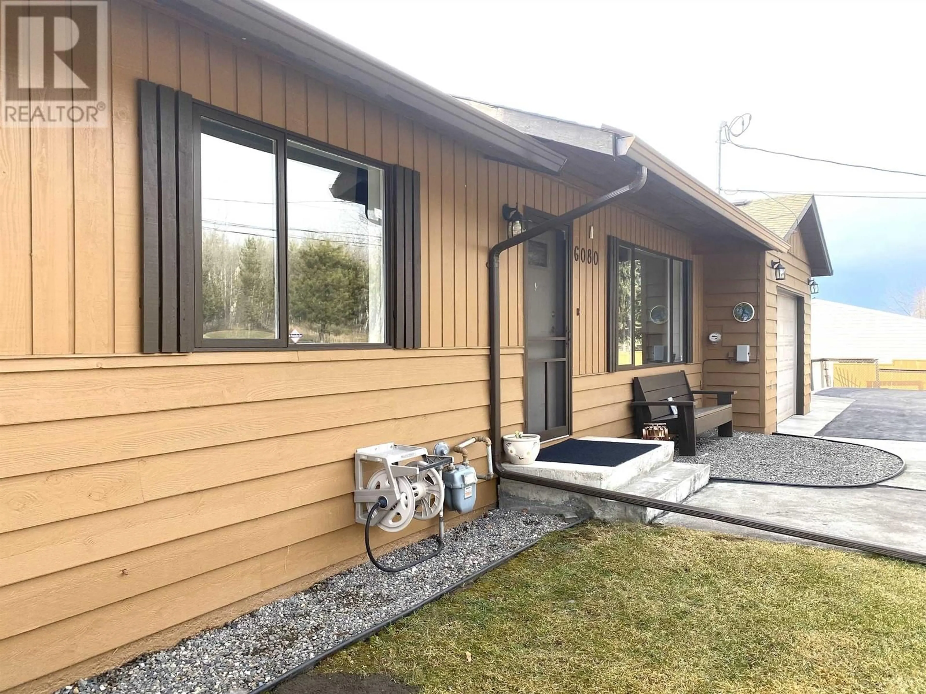 Home with vinyl exterior material, street for 6080 N HORSE LAKE ROAD, 100 Mile House British Columbia V0K2E3