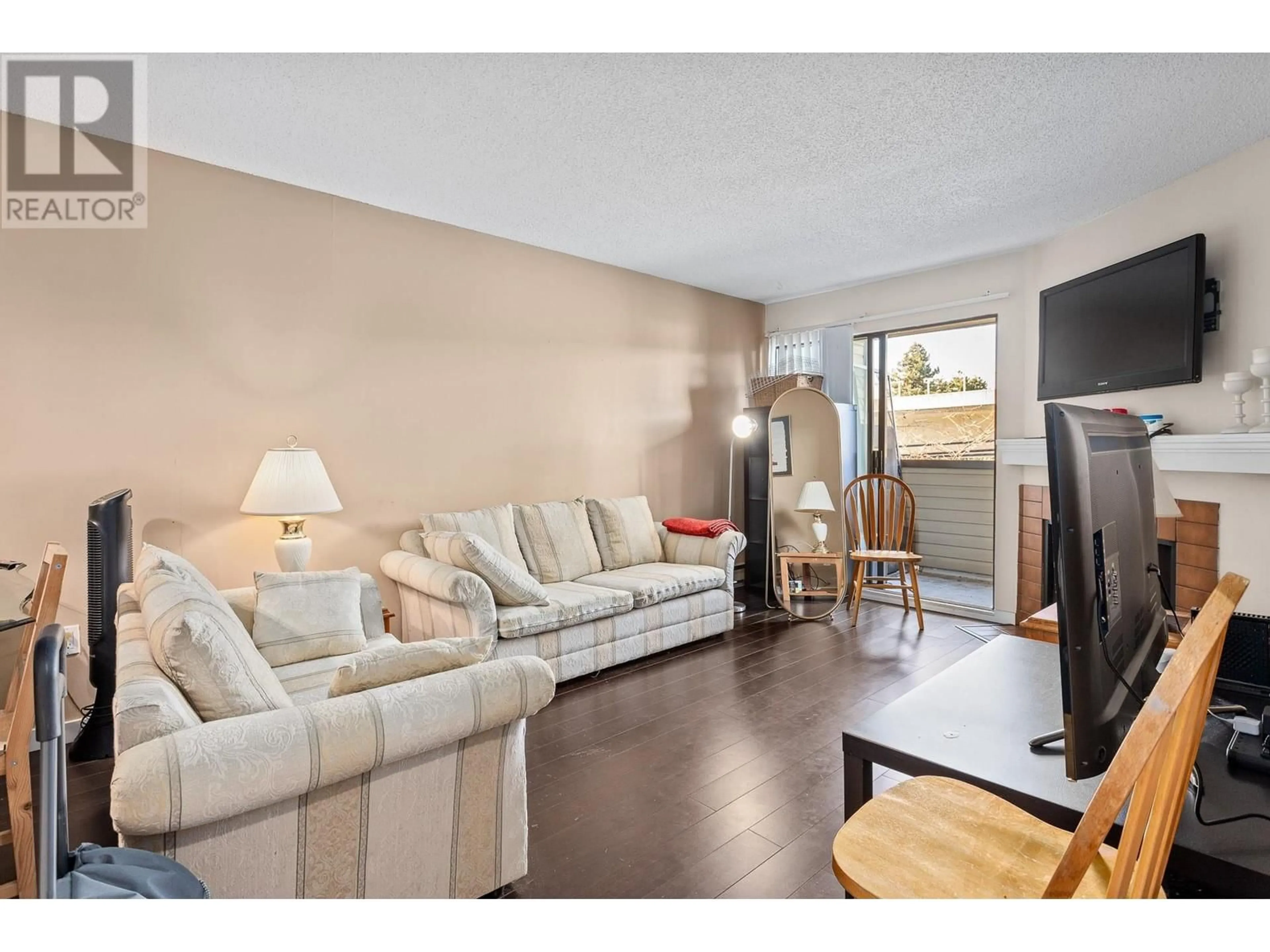 Living room with furniture, wood/laminate floor for 212 615 NORTH ROAD, Coquitlam British Columbia V3J1P1