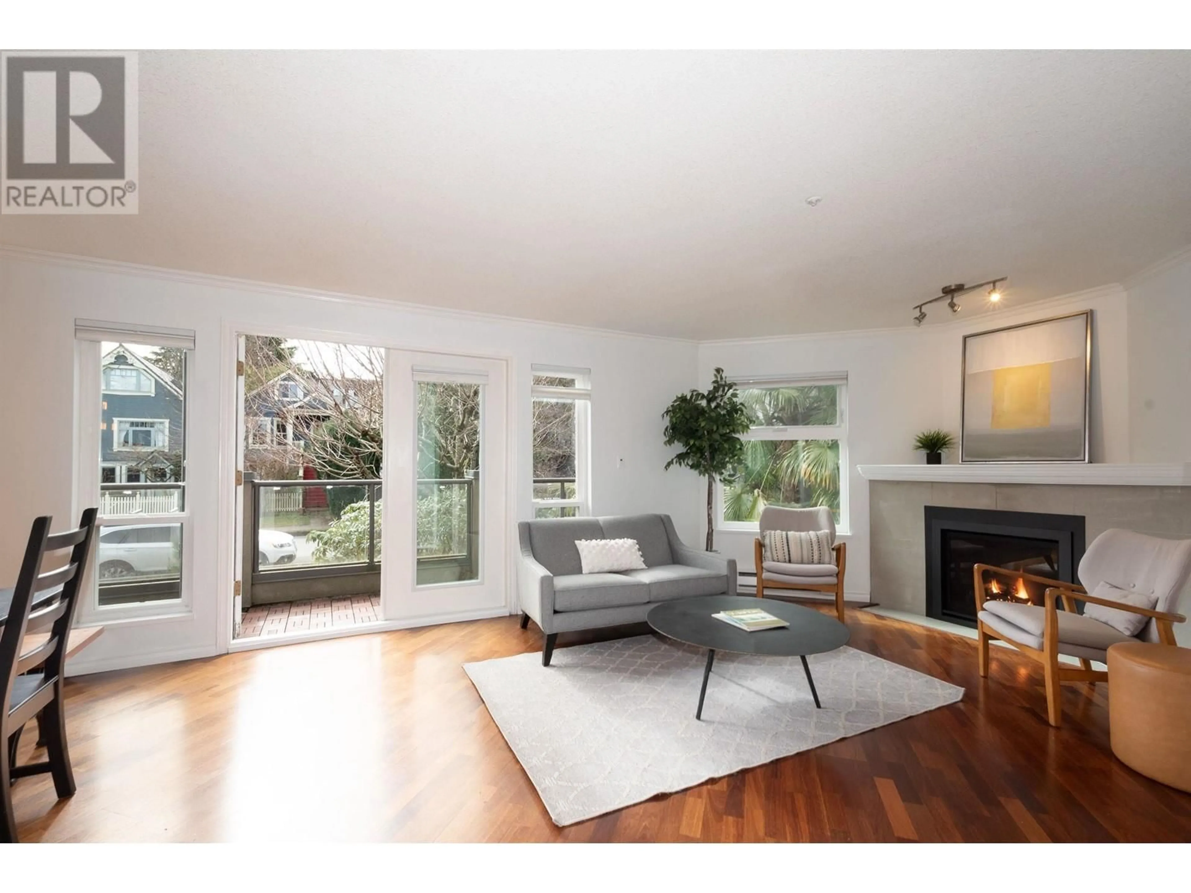 Living room with furniture, wood/laminate floor for 202 1959 W 2ND AVENUE, Vancouver British Columbia V6J1J2