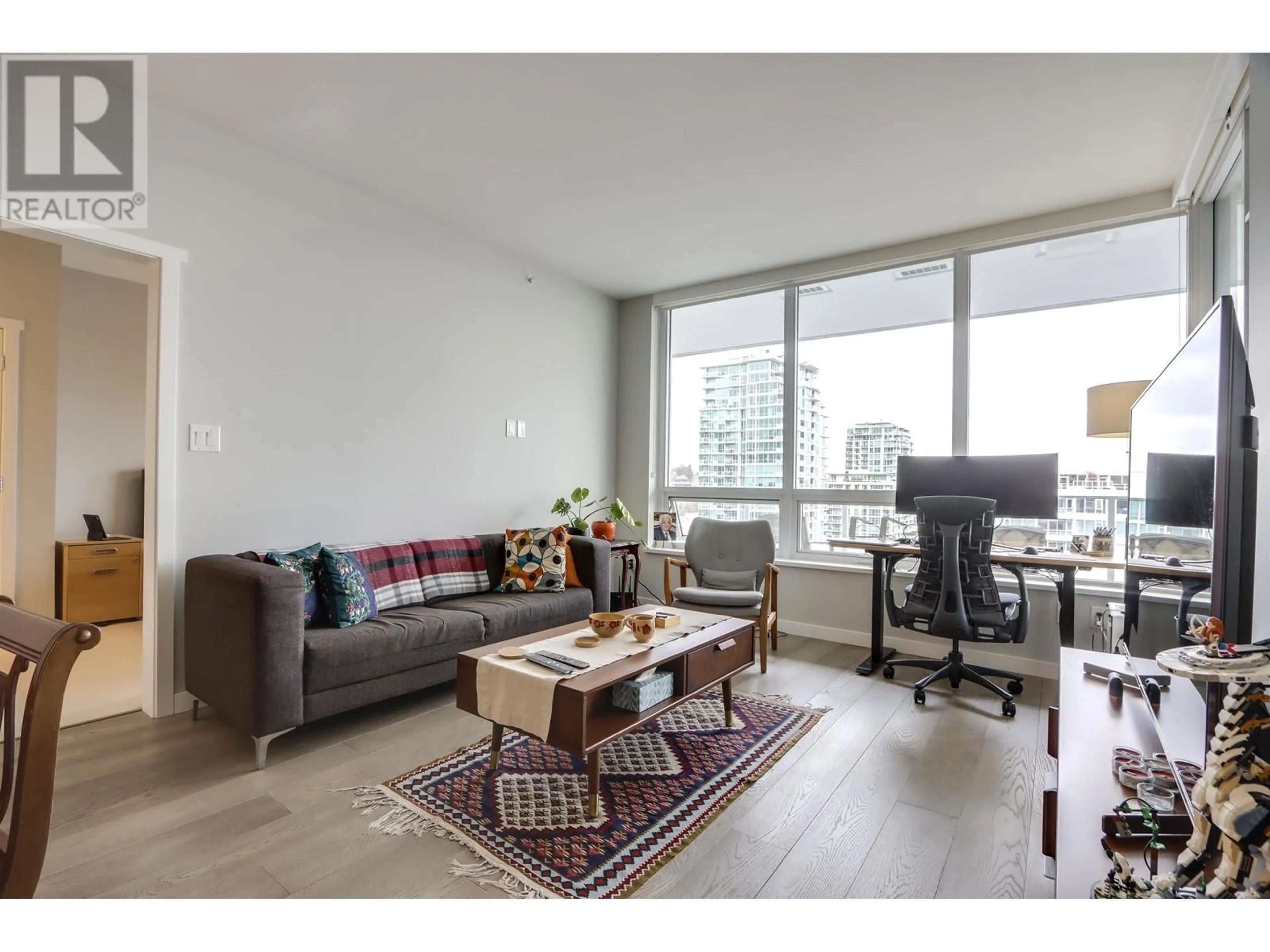 Living room with furniture, wood/laminate floor for 1208 118 CARRIE CATES COURT, Vancouver British Columbia V7M0G6