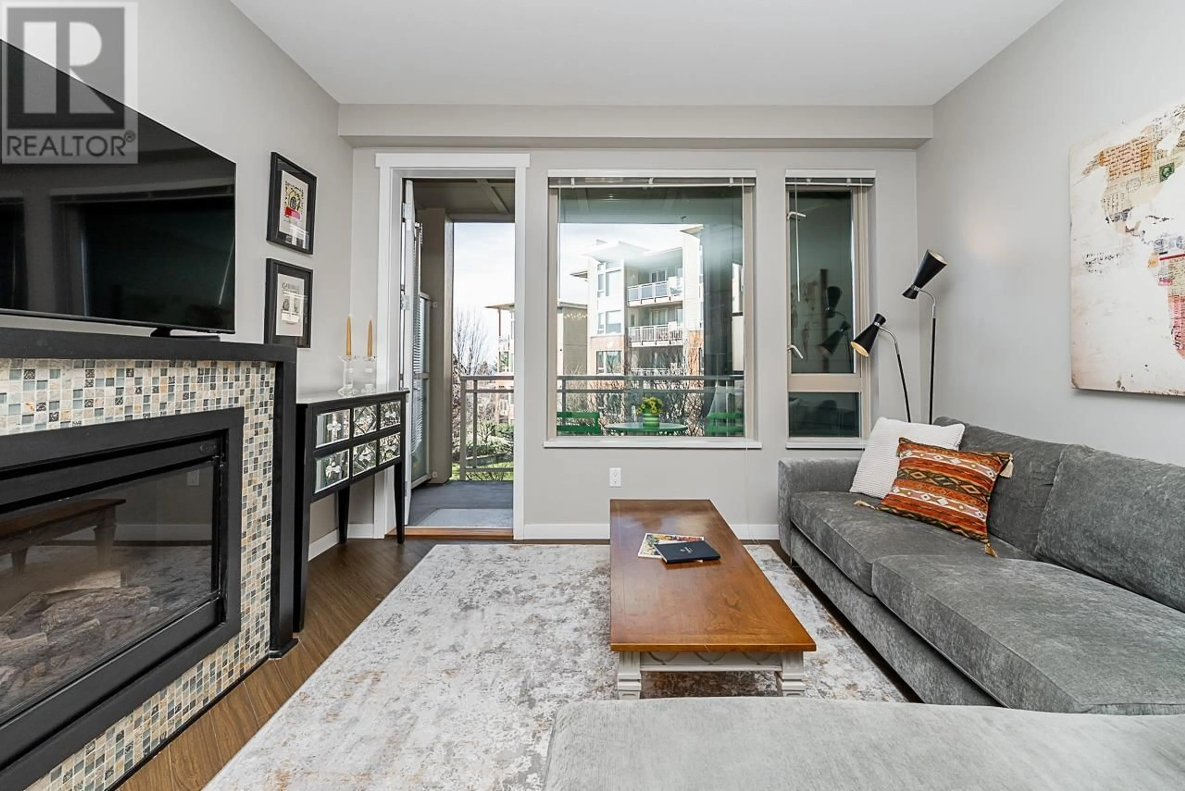 Living room with furniture, wood/laminate floor for 326 119 W 22ND STREET, North Vancouver British Columbia V7M0B4