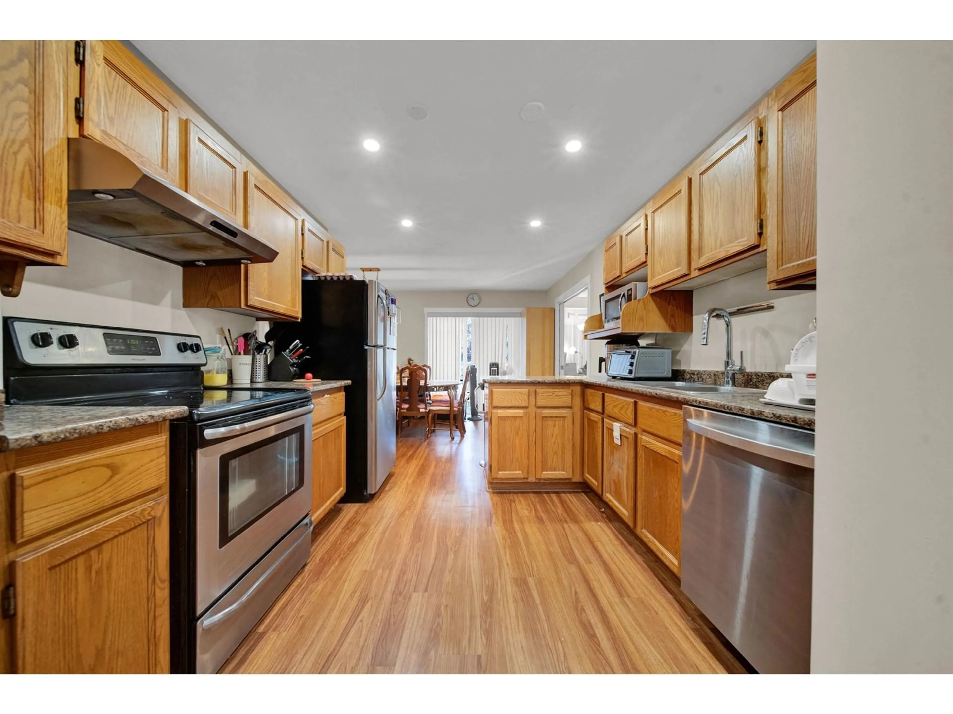 Open concept kitchen, wood/laminate floor for 232 - 5641 201, Langley British Columbia V3A8A4