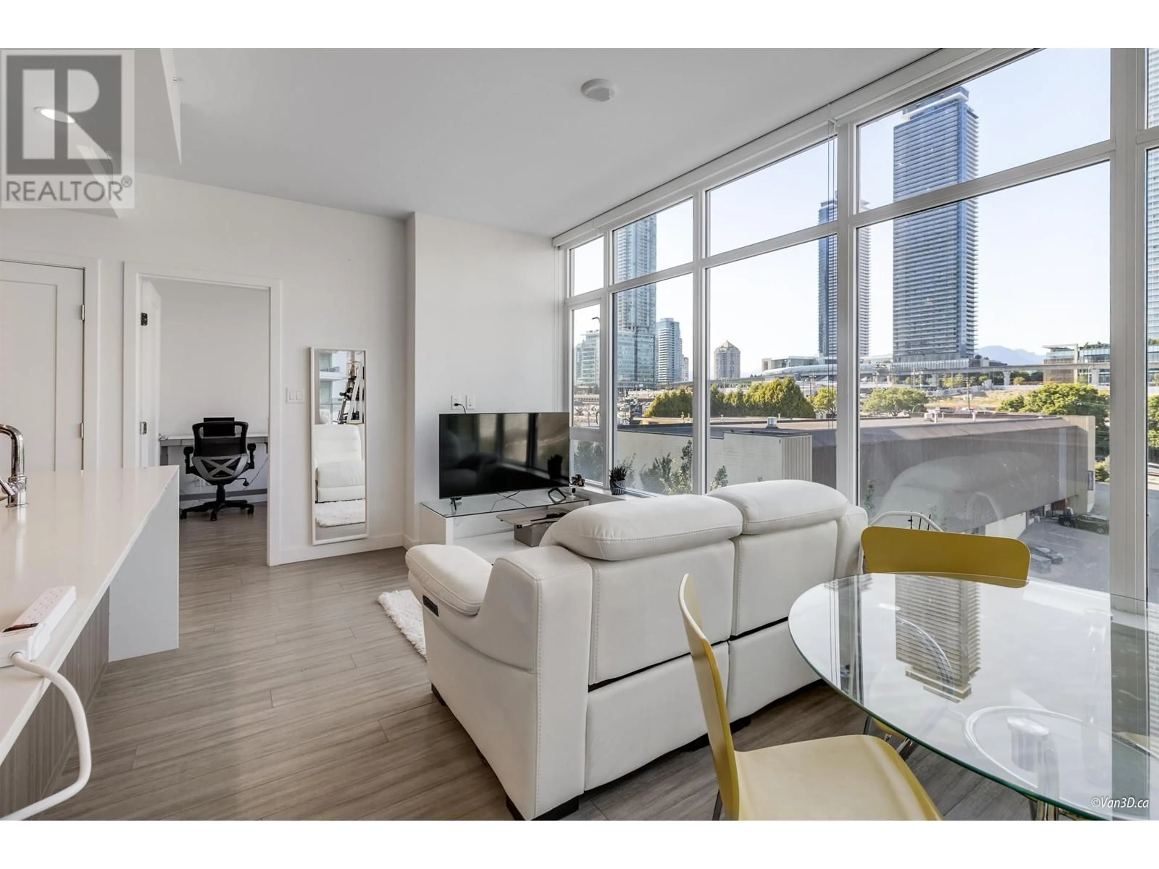 Living room with furniture, wood/laminate floor for 706 2311 BETA AVENUE, Burnaby British Columbia V5C0M1