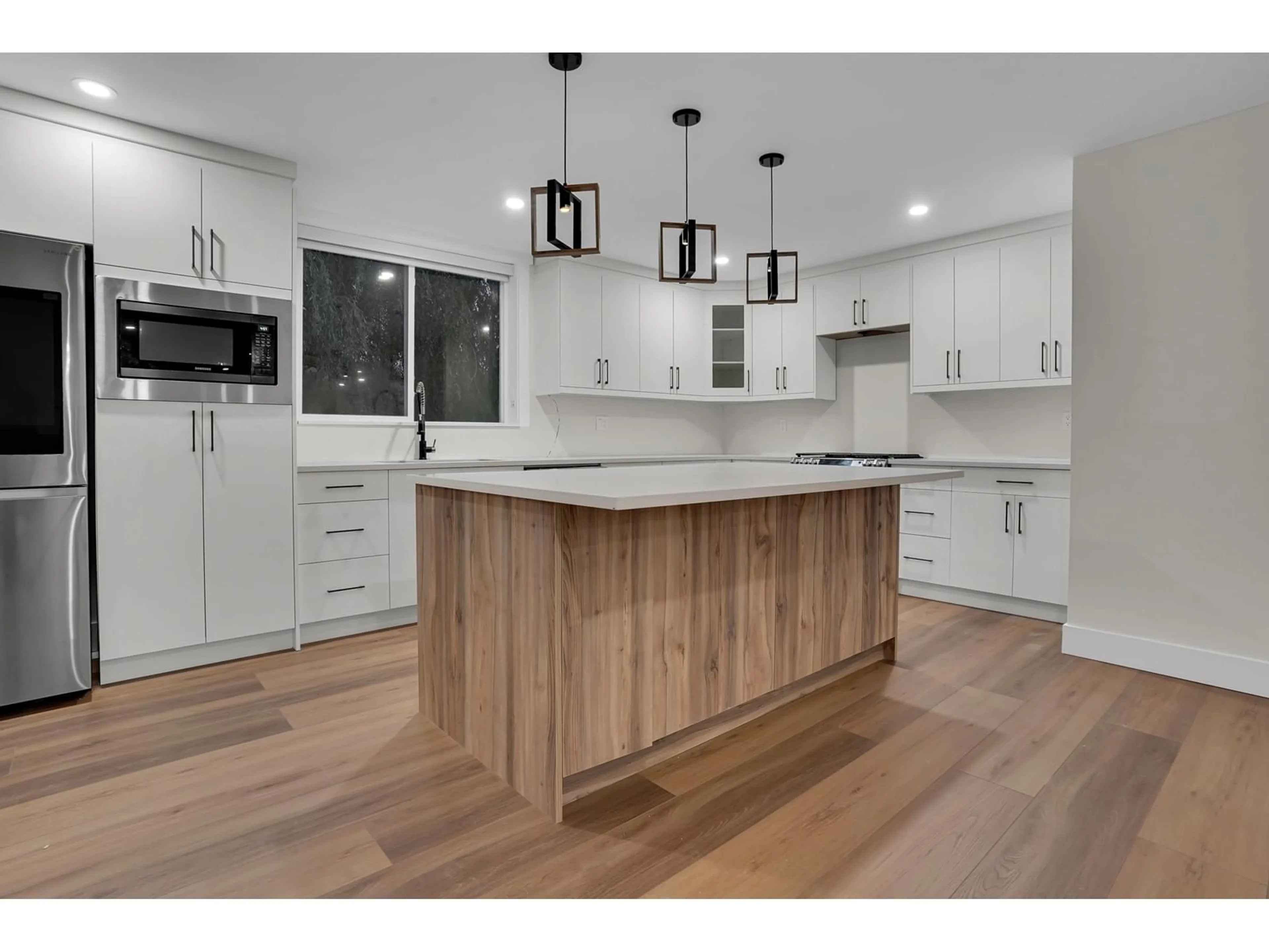 Open concept kitchen, wood/laminate floor for 4918 198B STREET, Langley British Columbia V3A6L4