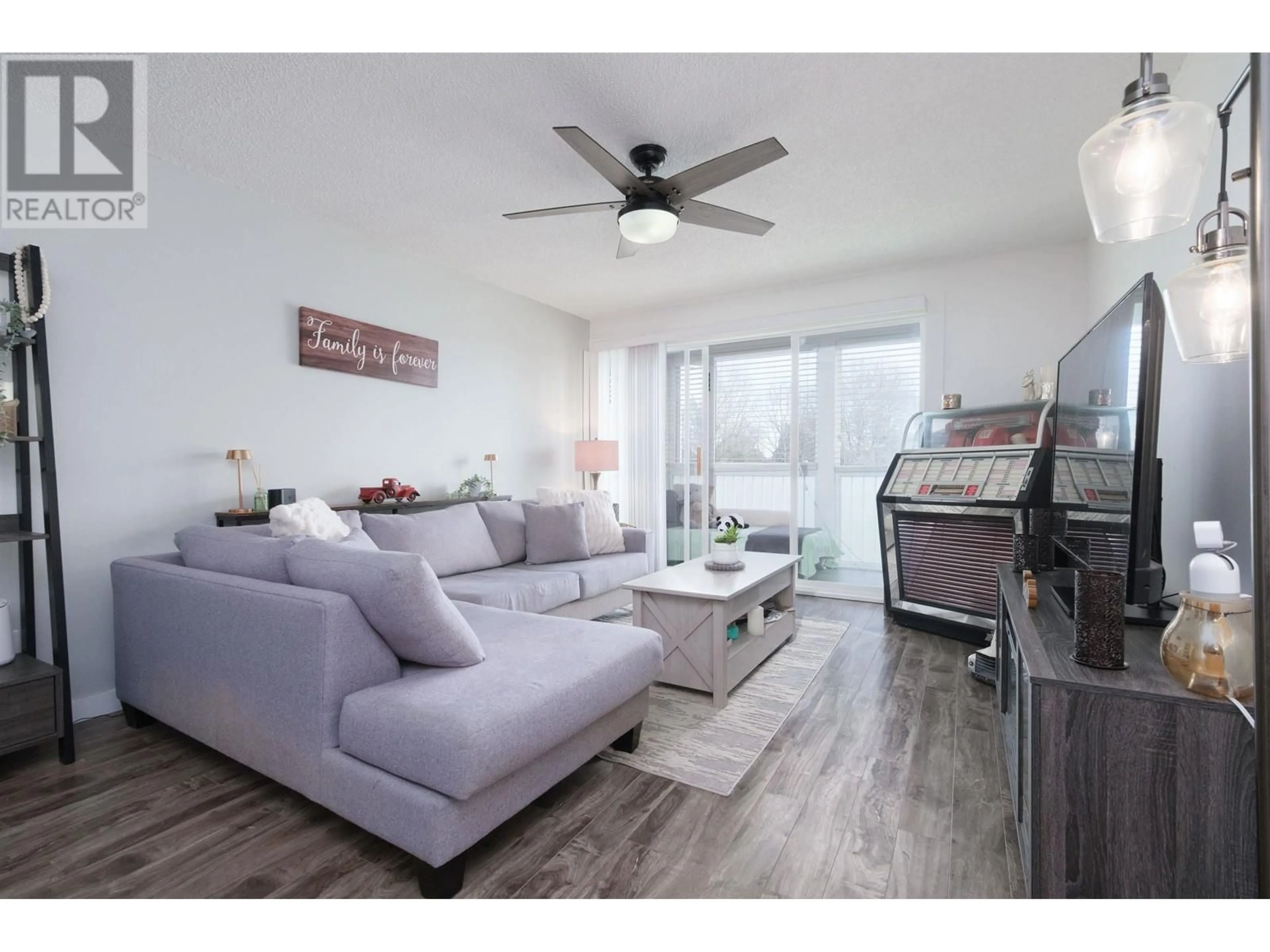 Living room with furniture, wood/laminate floor for 228 - 3451 SPRINGFIELD DRIVE, Richmond British Columbia V7E1Z2