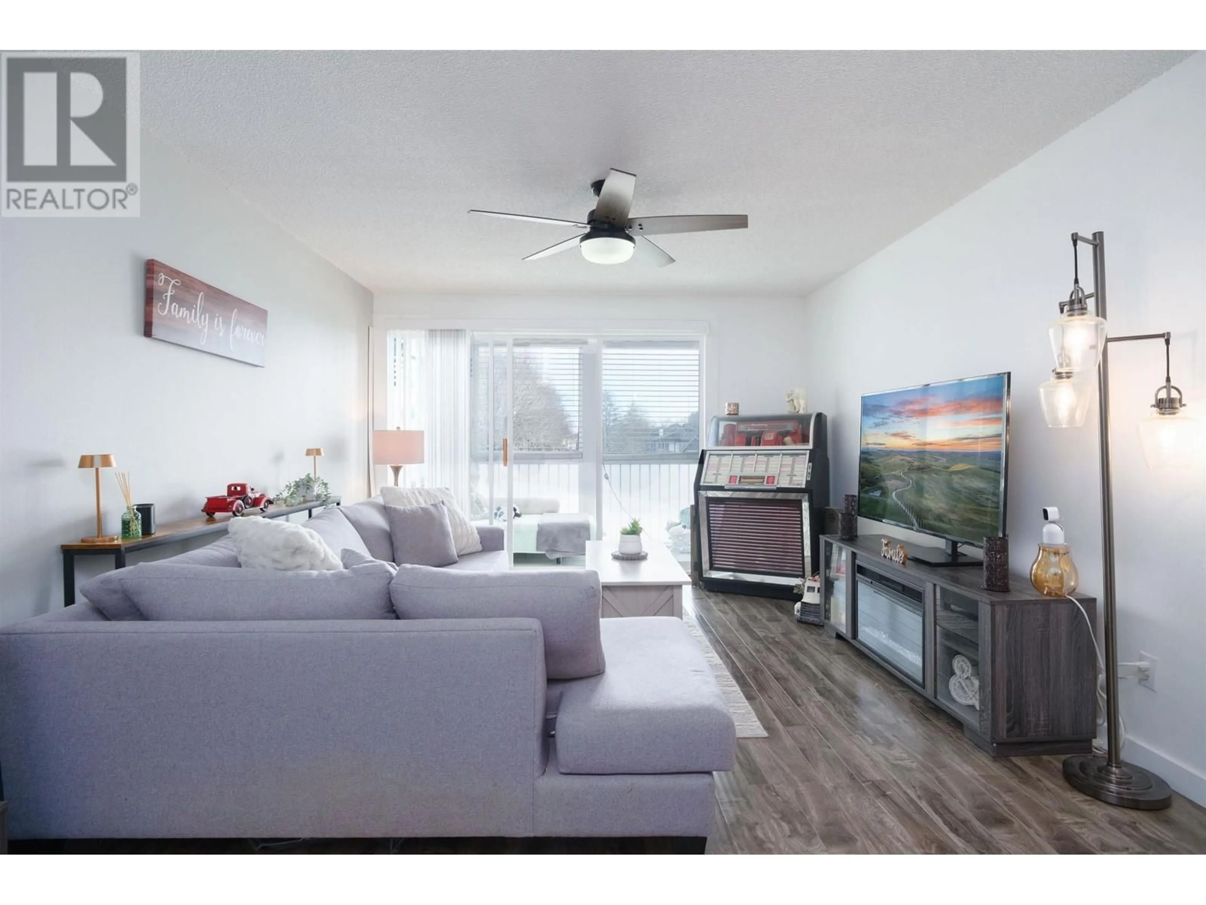 Living room with furniture, wood/laminate floor for 228 - 3451 SPRINGFIELD DRIVE, Richmond British Columbia V7E1Z2