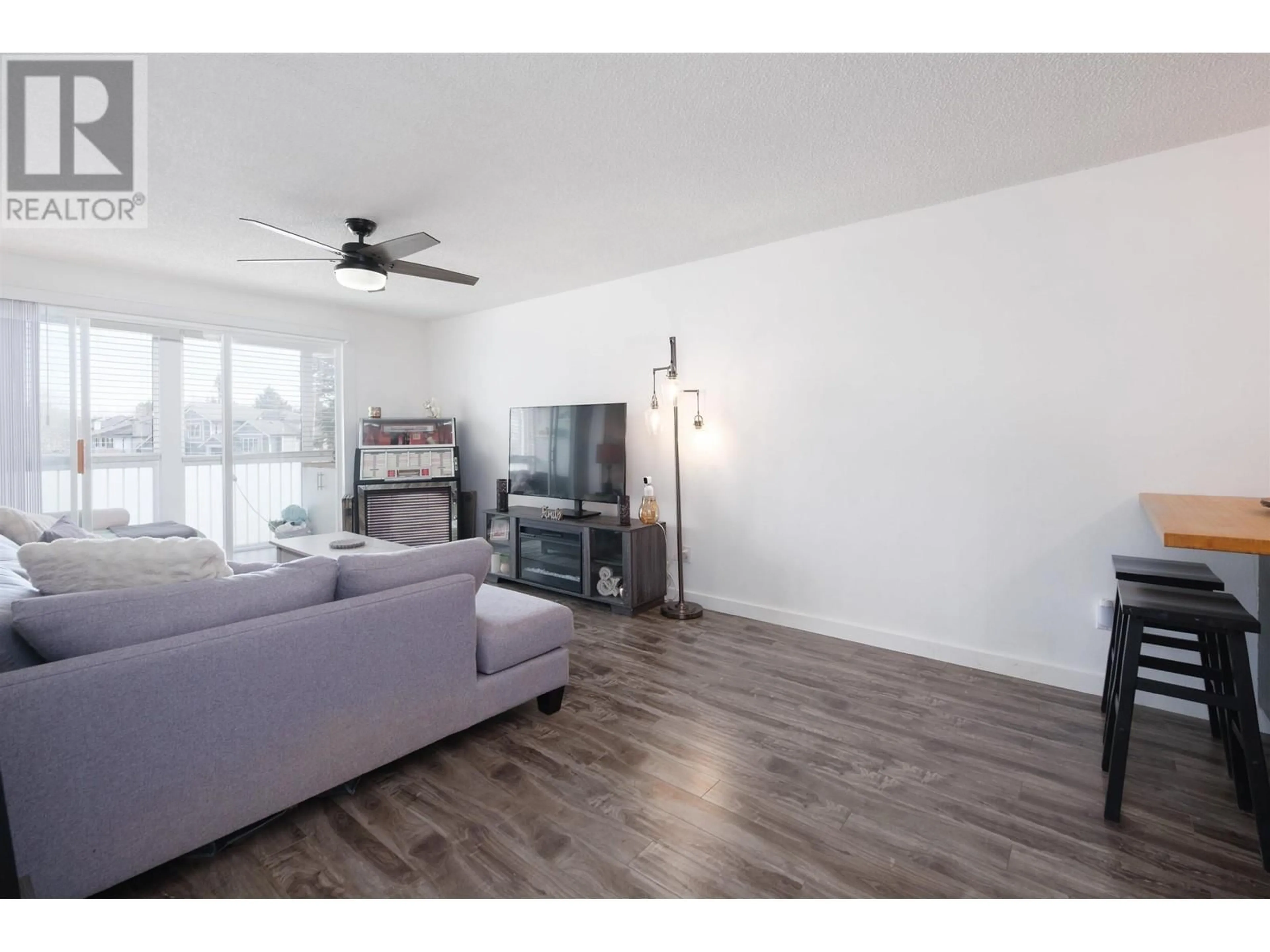 Living room with furniture, wood/laminate floor for 228 - 3451 SPRINGFIELD DRIVE, Richmond British Columbia V7E1Z2