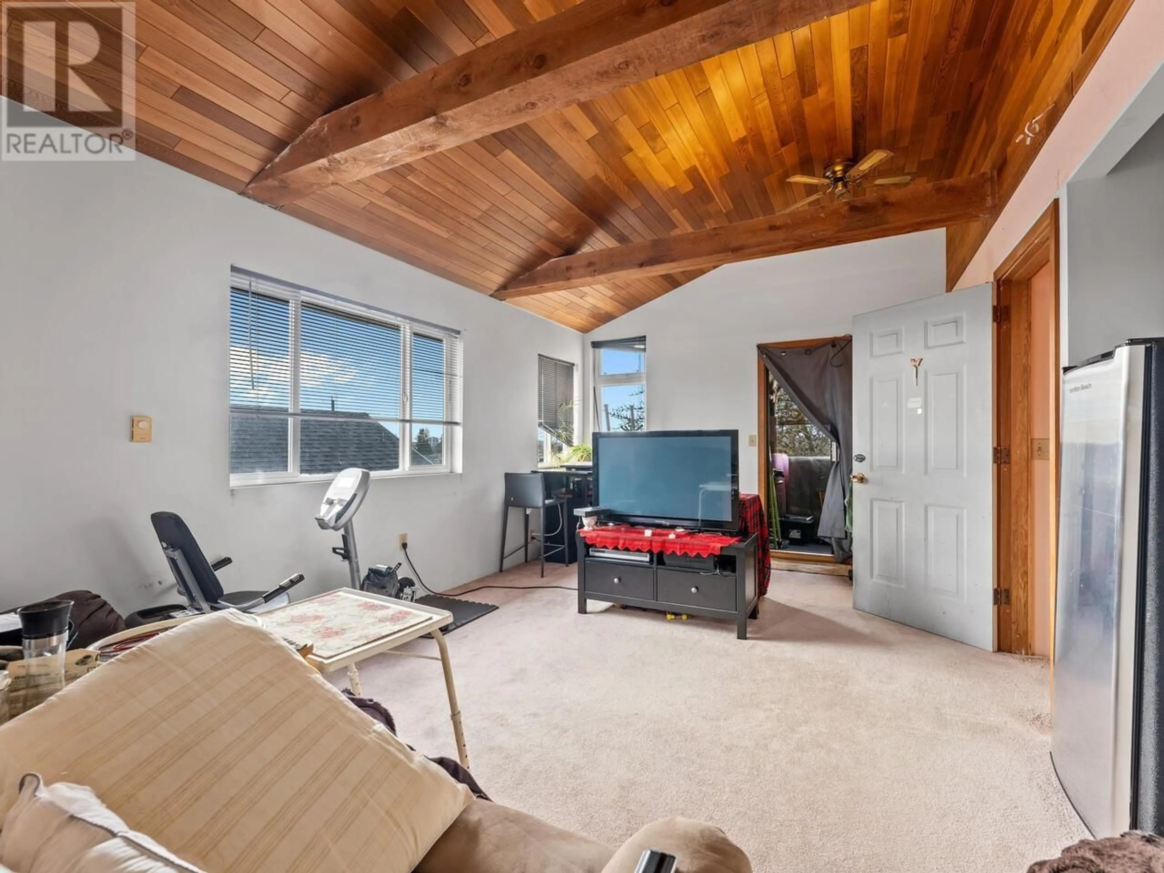 Living room with furniture, wood/laminate floor for 4535 RUPERT STREET, Vancouver British Columbia V5R2J4