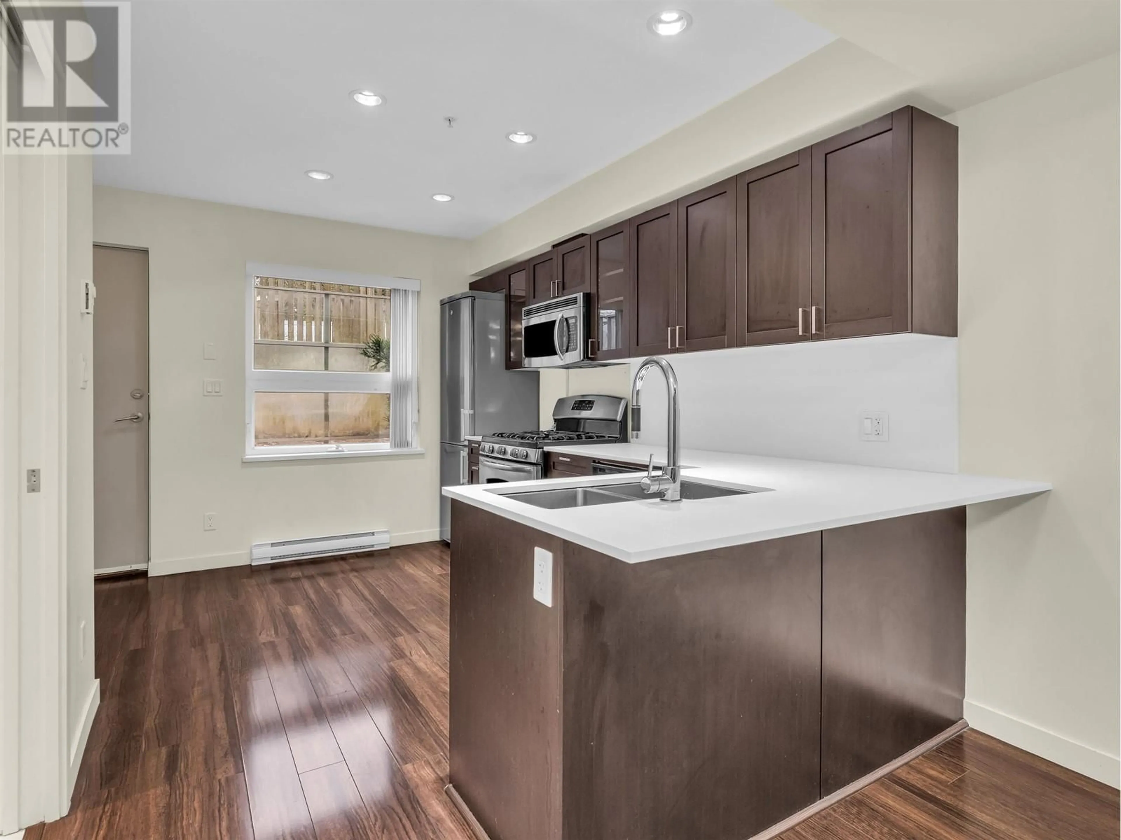 Open concept kitchen, wood/laminate floor for 4858 ELDORADO MEWS, Vancouver British Columbia V5R0B1