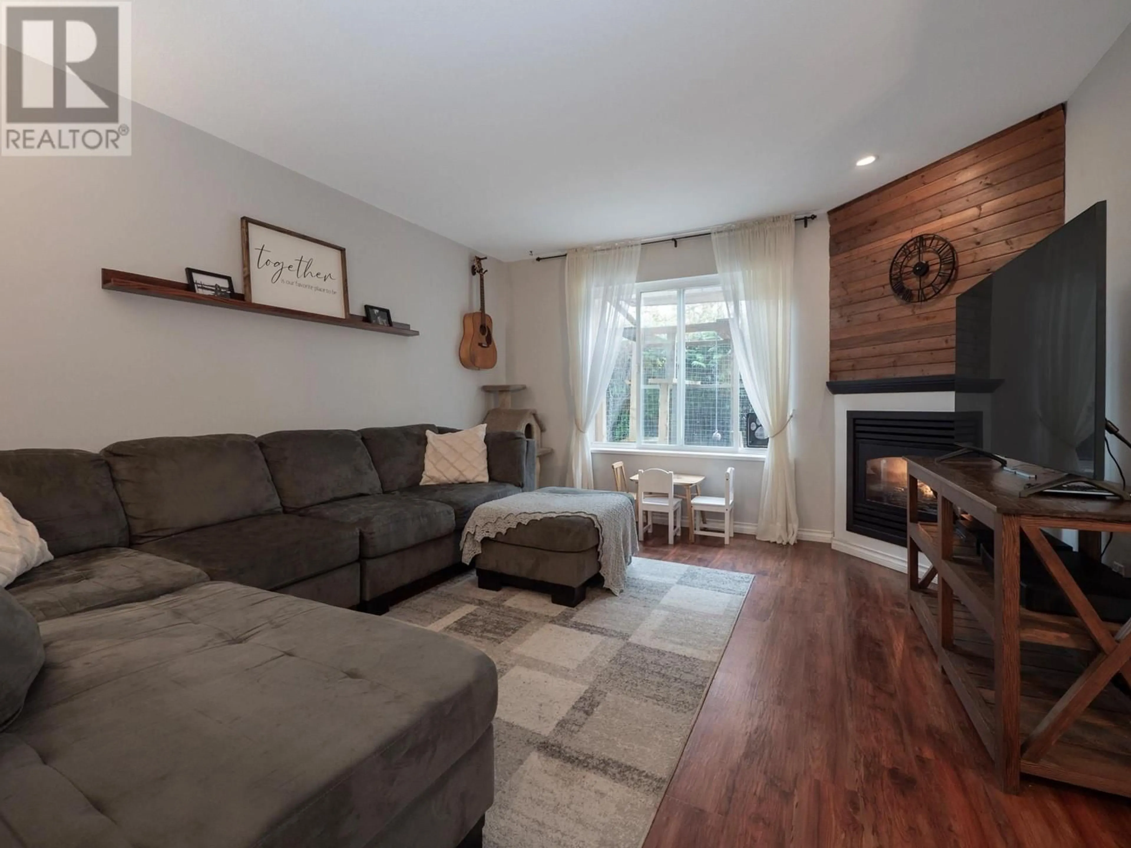 Living room with furniture, wood/laminate floor for 111 - 5711 EBBTIDE STREET, Sechelt British Columbia V7Z0J5