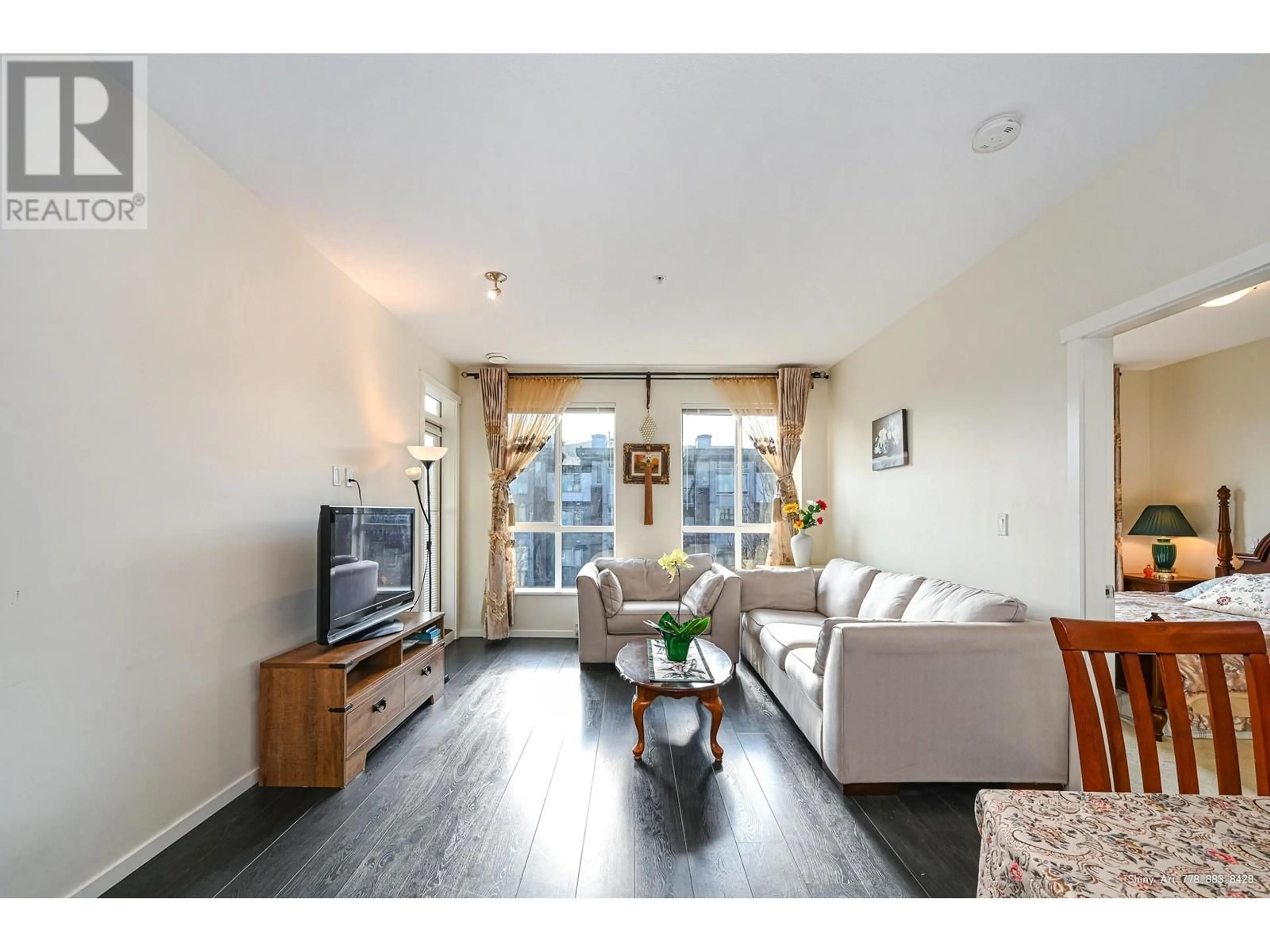 Living room with furniture, wood/laminate floor for 301 - 3107 WINDSOR GATE, Coquitlam British Columbia V3B0L1