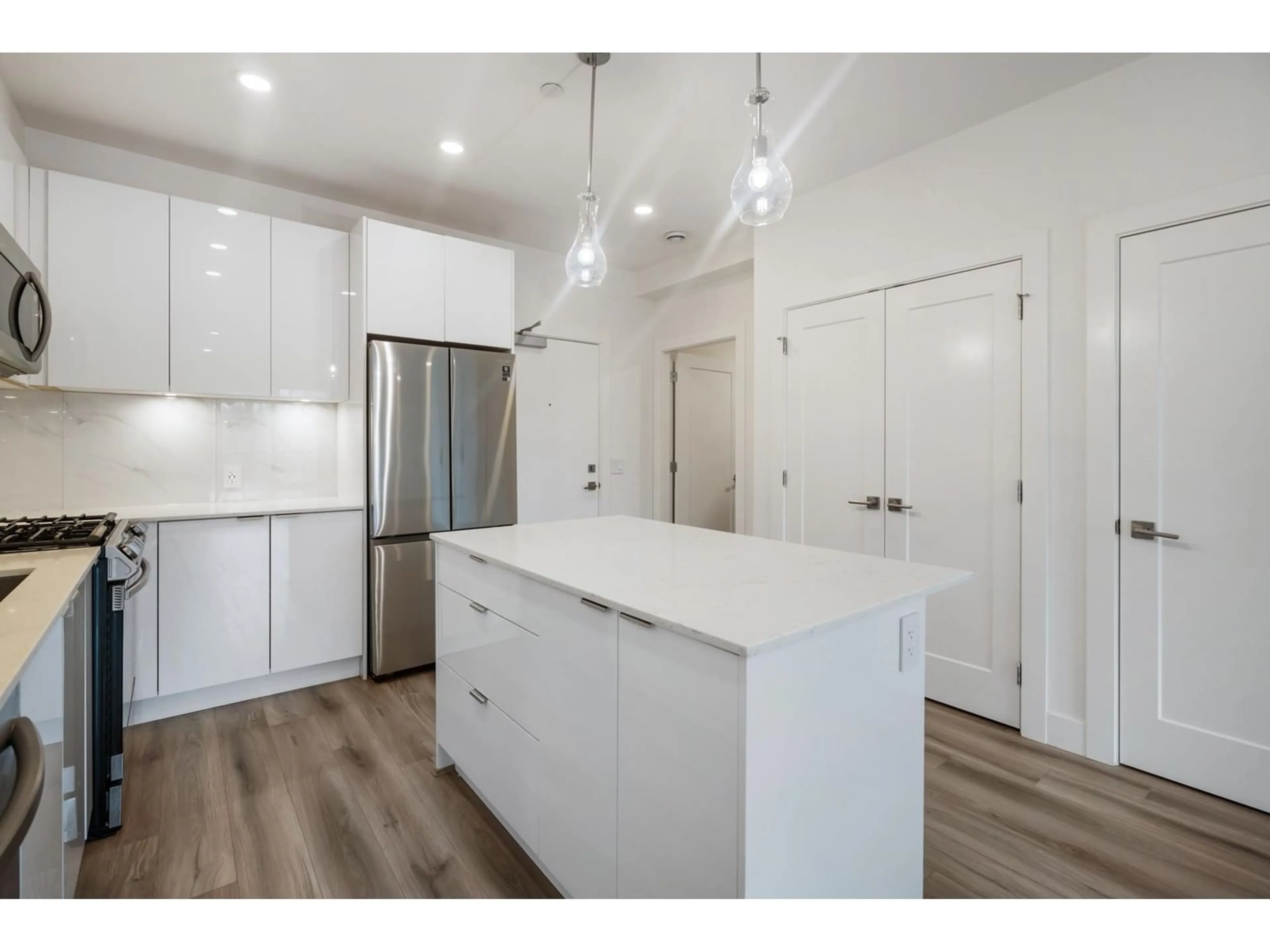 Open concept kitchen, wood/laminate floor for B310 - 8447 202, Langley British Columbia V2Y2B7