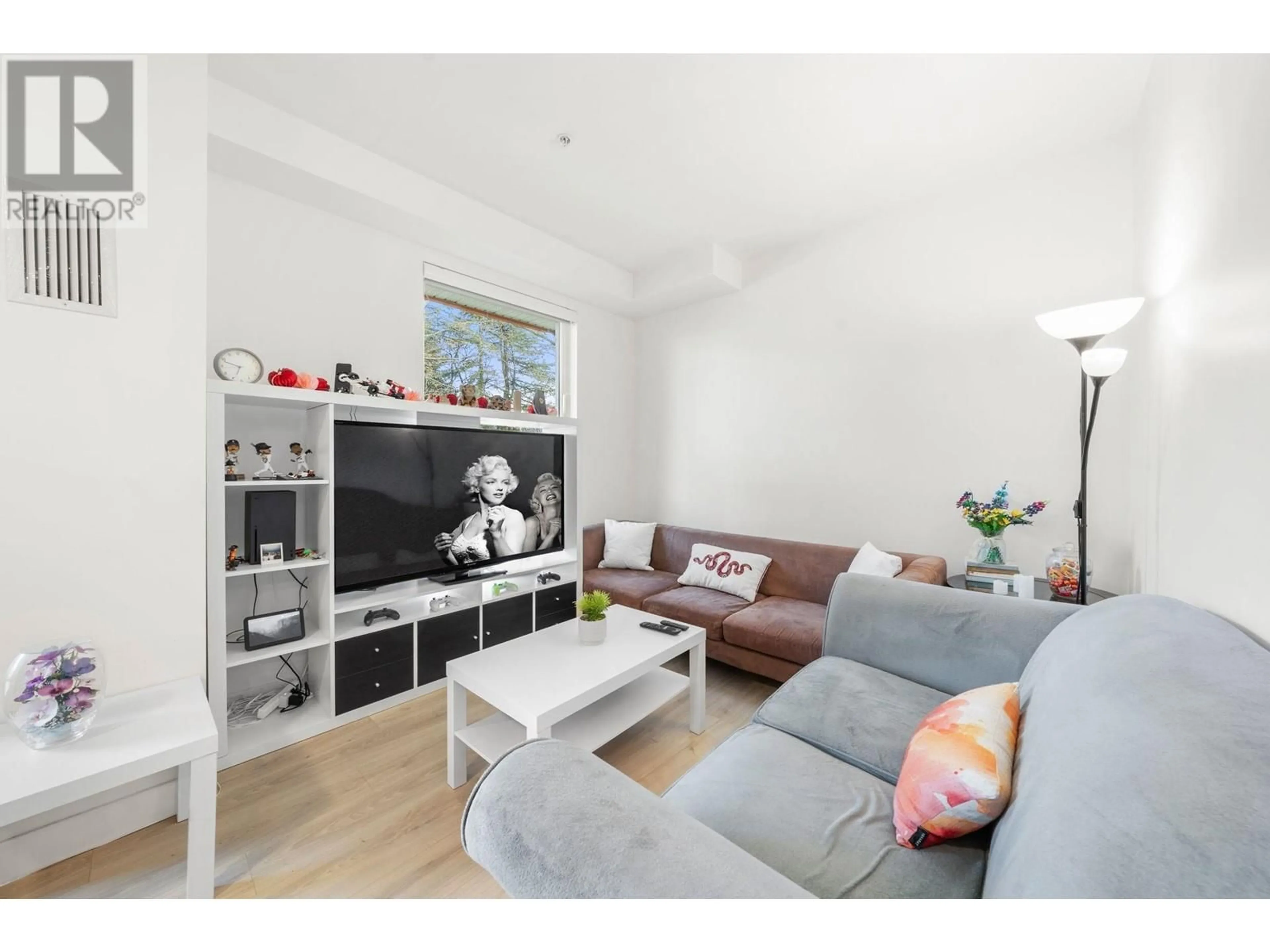 Living room with furniture, wood/laminate floor for 105 - 2688 DUKE STREET, Vancouver British Columbia V5R4S9